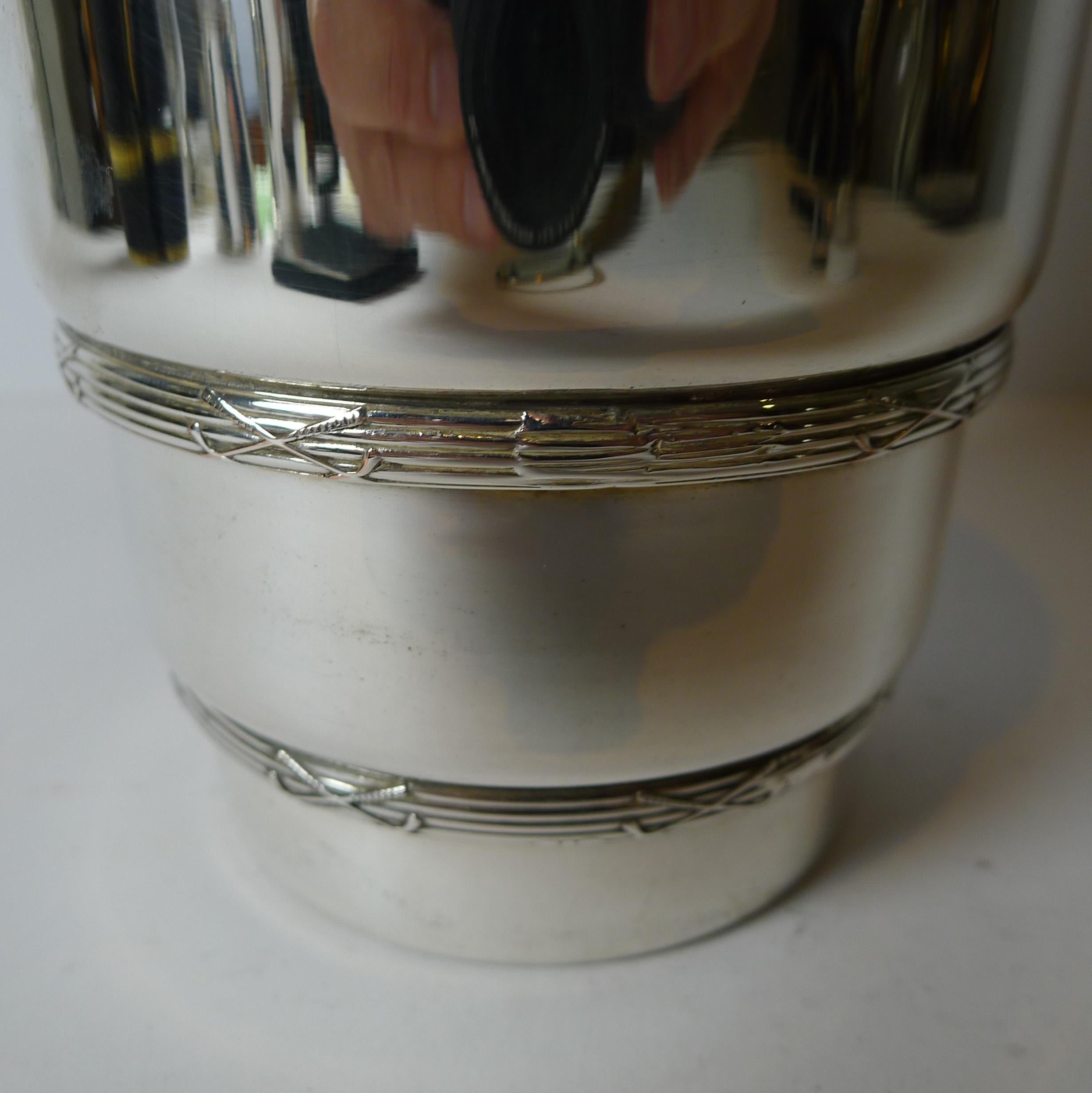 A magnificent Golf inspired cocktail shaker, made from silver plate by the well renowned silversmith, James Dixon & Sons, fully signed on the underside.

The top is in the form of a golf ball and the linear raised decoration the base is enhanced all