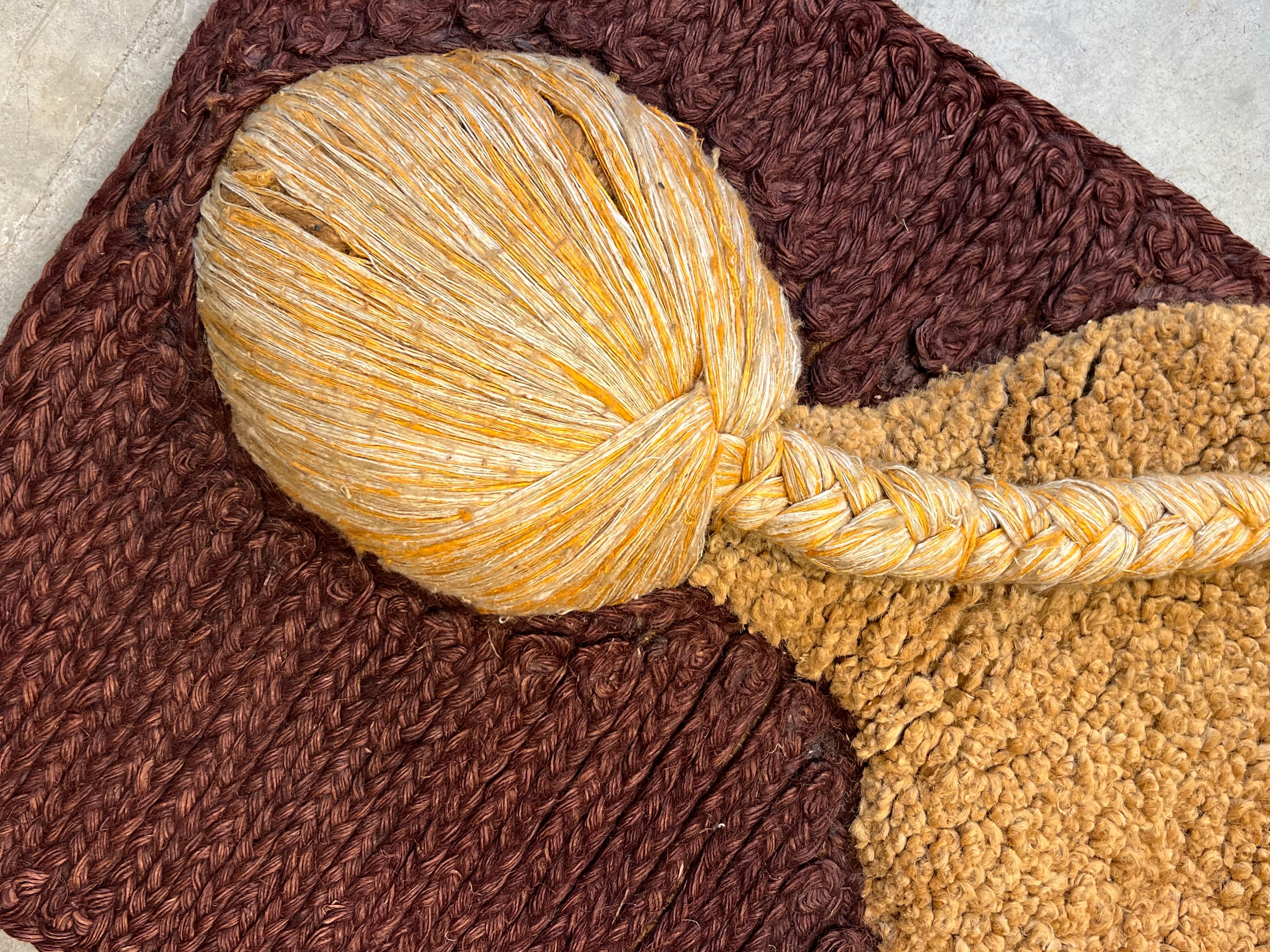 Vintage textile wall art depicting a sitting nude woman with back turned. Designed by mid-century textile artist Don Freedman, circa 1970s, with original maker’s mark embellishing and original tag. This piece has neutral tones with a pop of burgundy