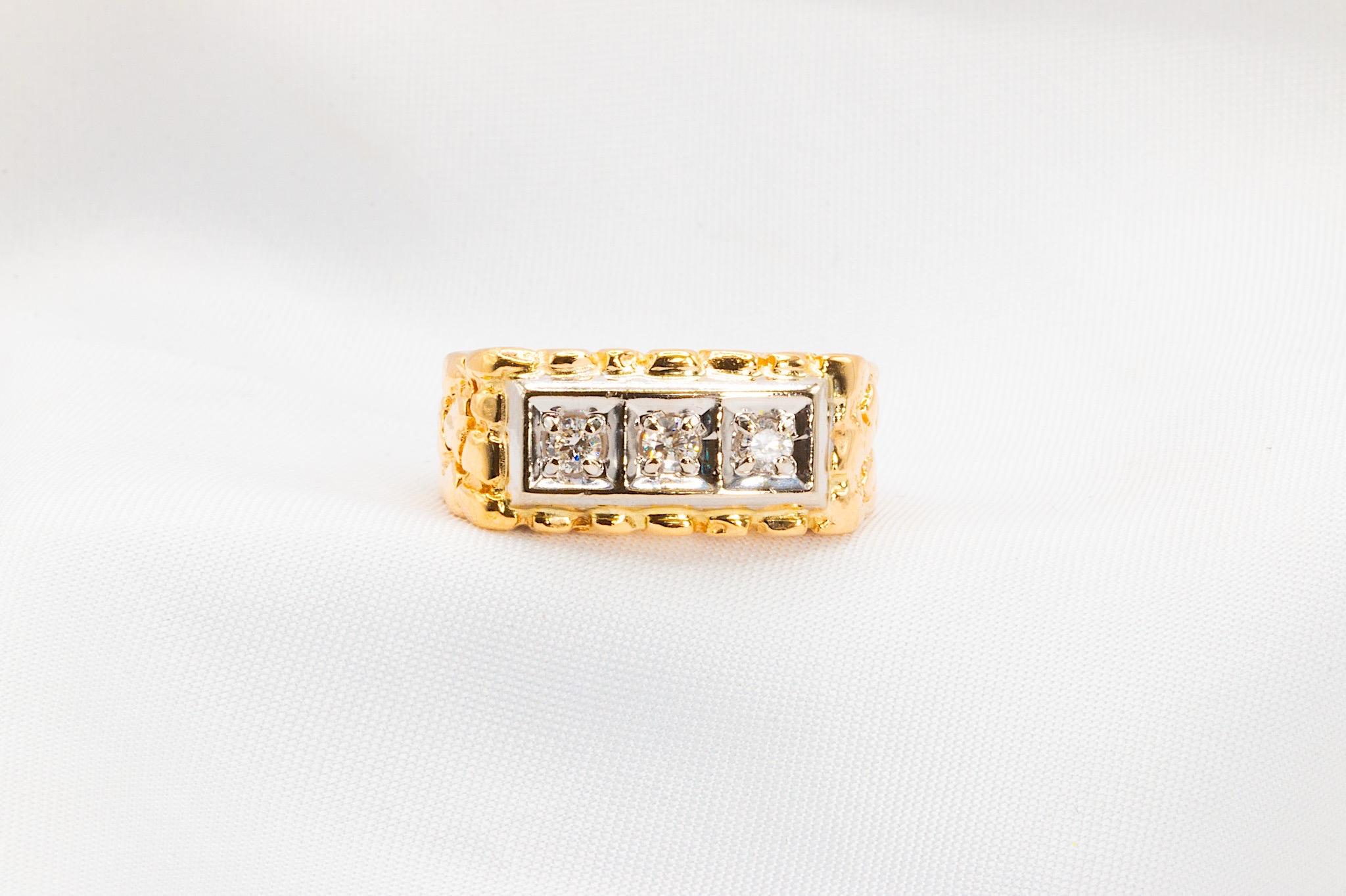 Sure to catch the eye and start conversations, this nugget-style band featured three prong-set round brilliant diamonds, totaling approximately 0.21 carats in weight. They are graded G-H in color and SI in clarity.

This band tapers from 9.2mm to