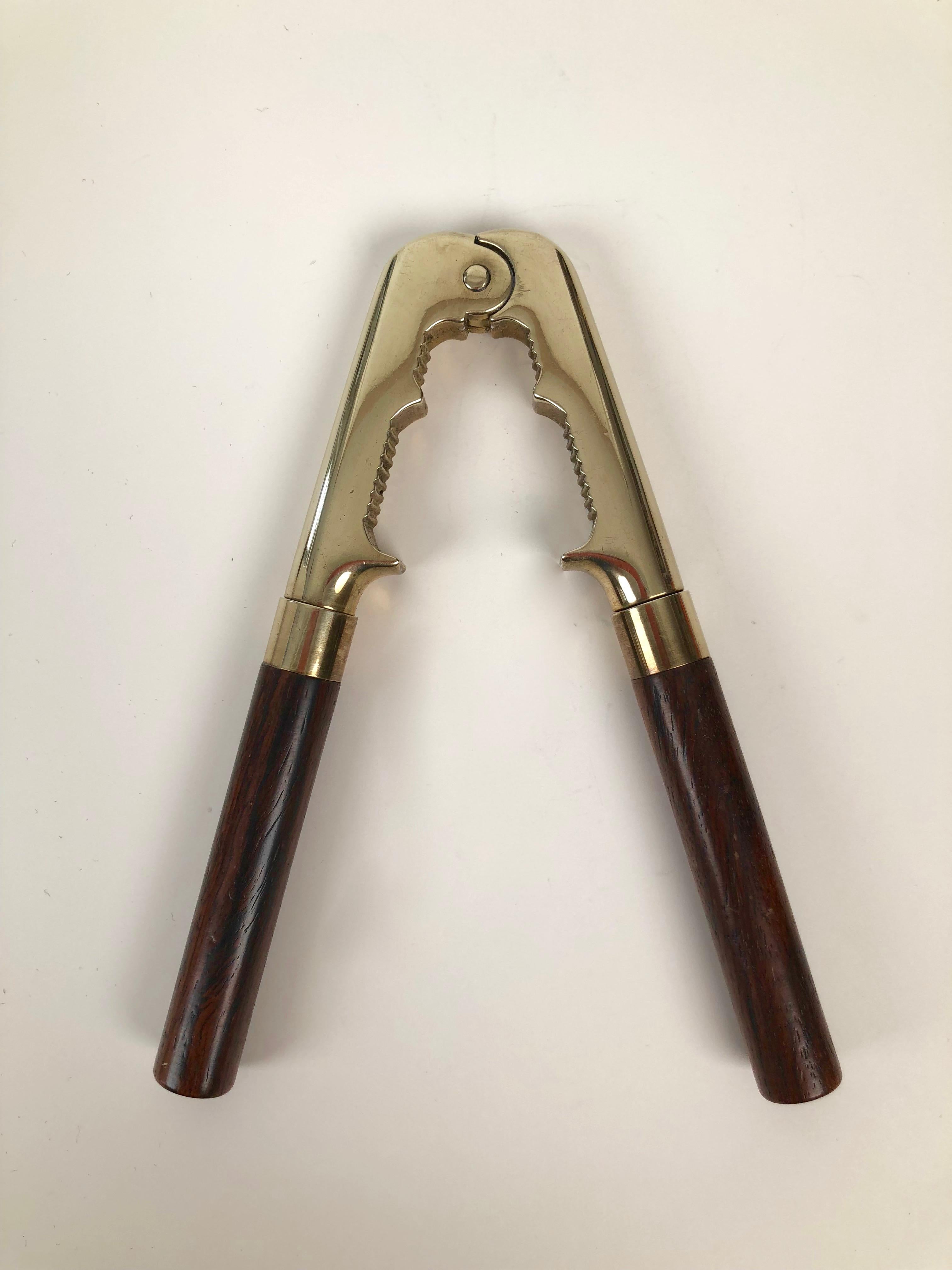 Vintage nut cracker from the 1970s, made from forged brass and palisander wood.
It is very heavy but has good ergonomics.