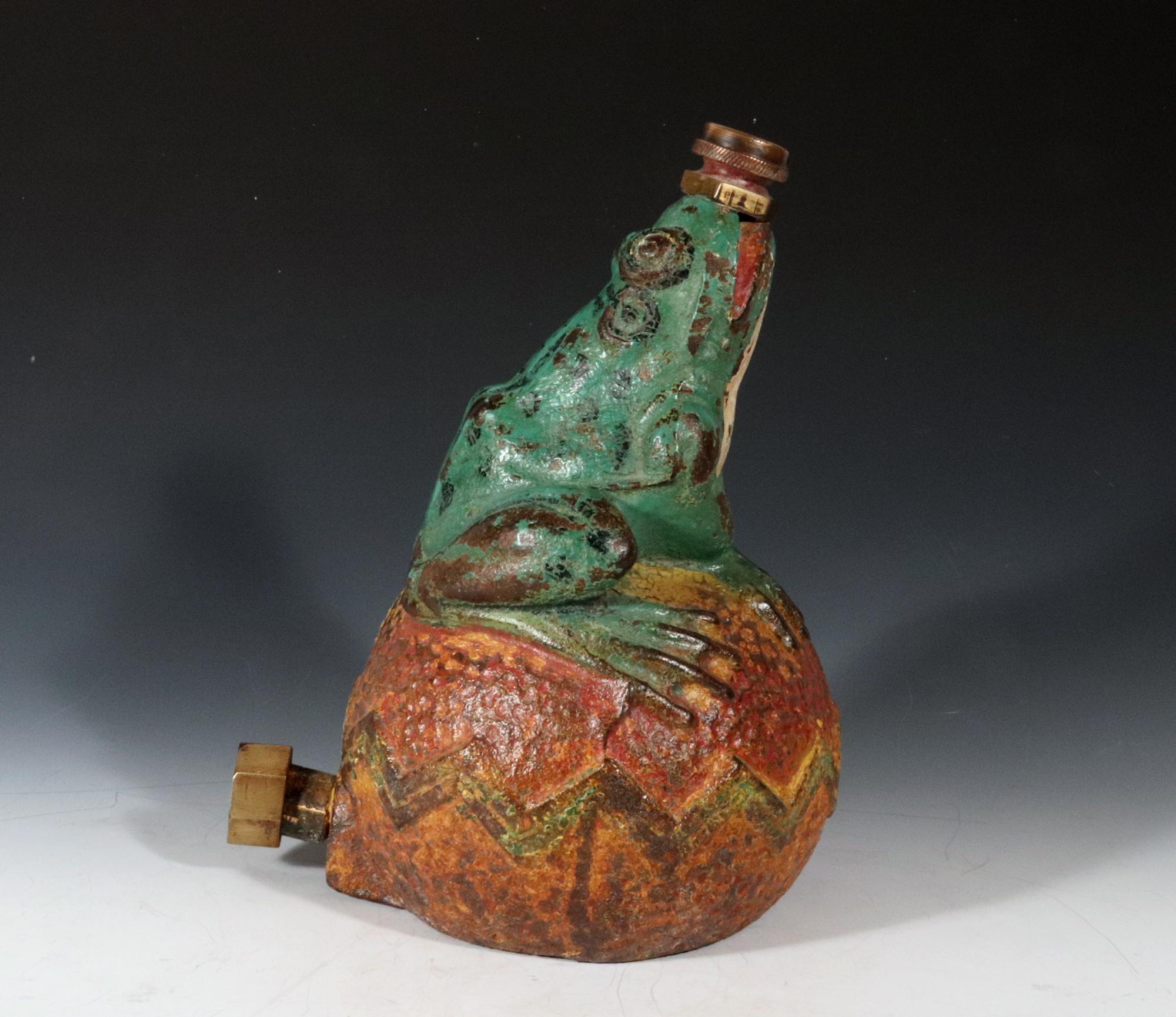 Vintage Lawn Sprinkler,
A Frog on a Ball,
Nuydea Foundry
1920s-30s

The working lawn sprinkler is in the form of a green frog sitting on a ball with a zig-zag design around the circumference. It has brass fitting to the mouth and the back