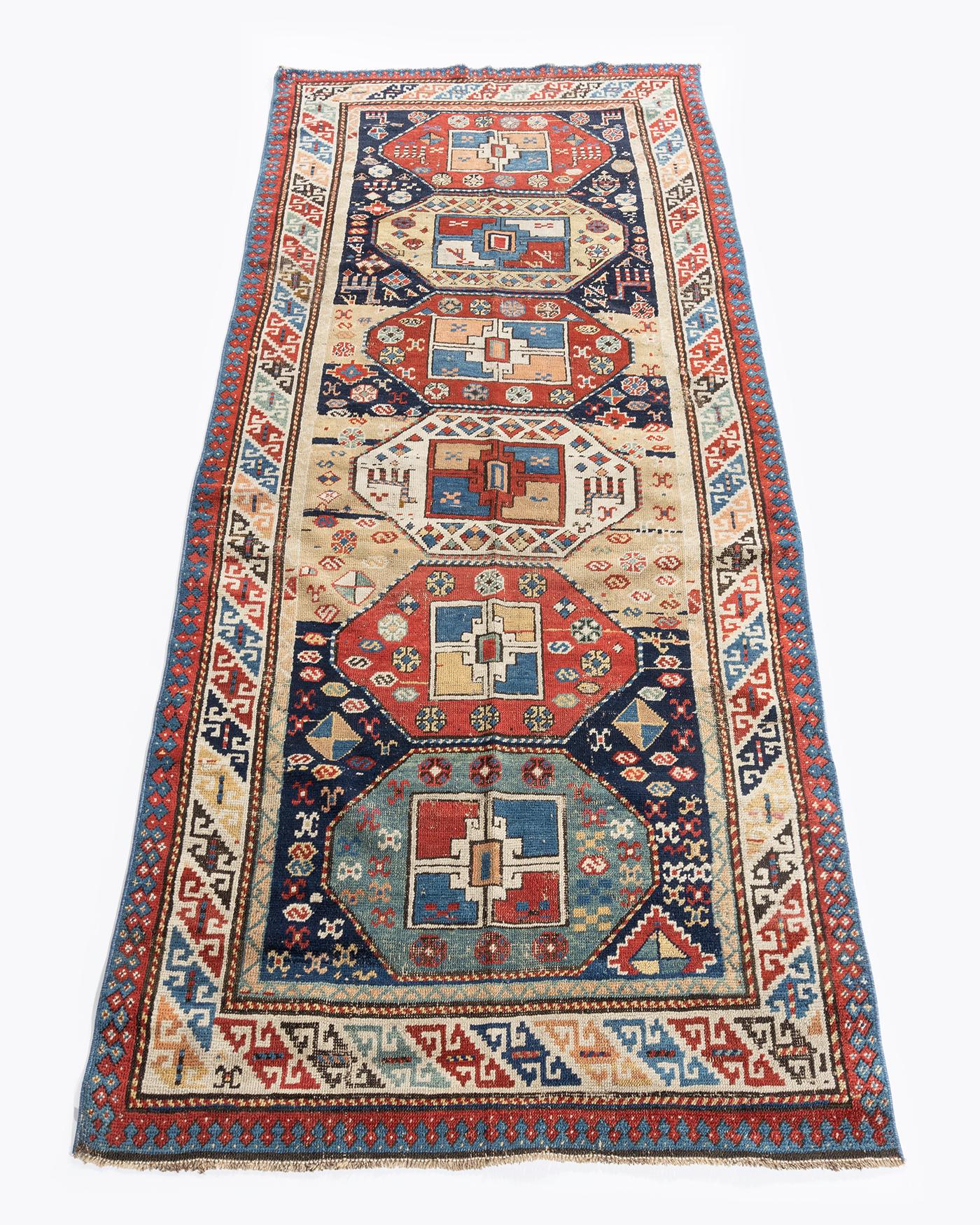 3'4 X 8'5. A wonderful NW Persian runner with a wide variety of colors and designs including animal figures incorporated into the piece. Colors; blues/brick/pale yellow/ivory