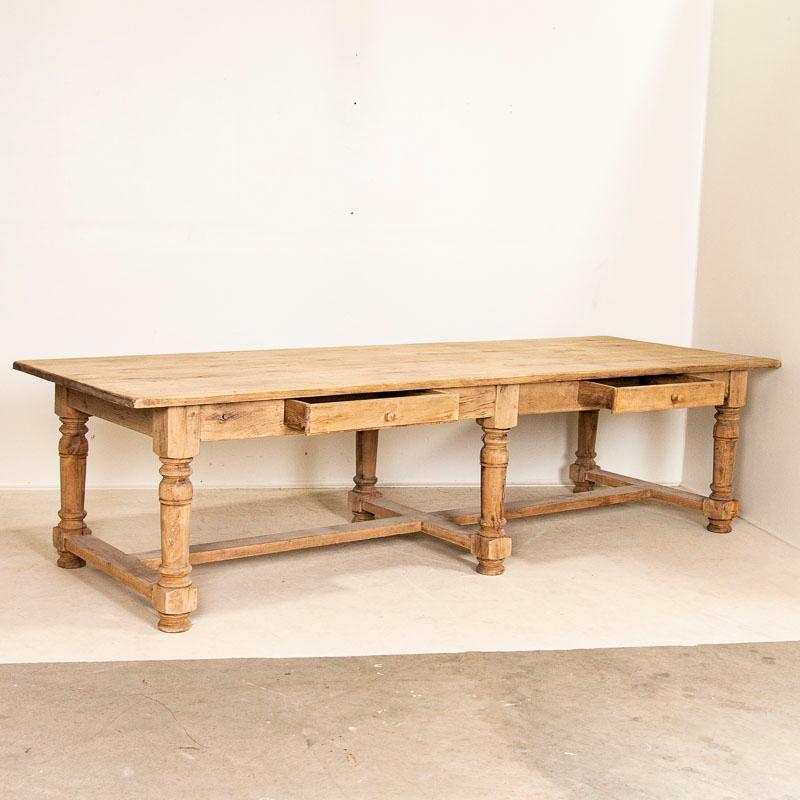 The heavy turned legs and stretchers along the bottom are traditional style elements of a refectory table. At 10' long, this solid oak table will serve impressively as a huge dining table, kitchen island or long buffet. Note the use of wood pegs vs.