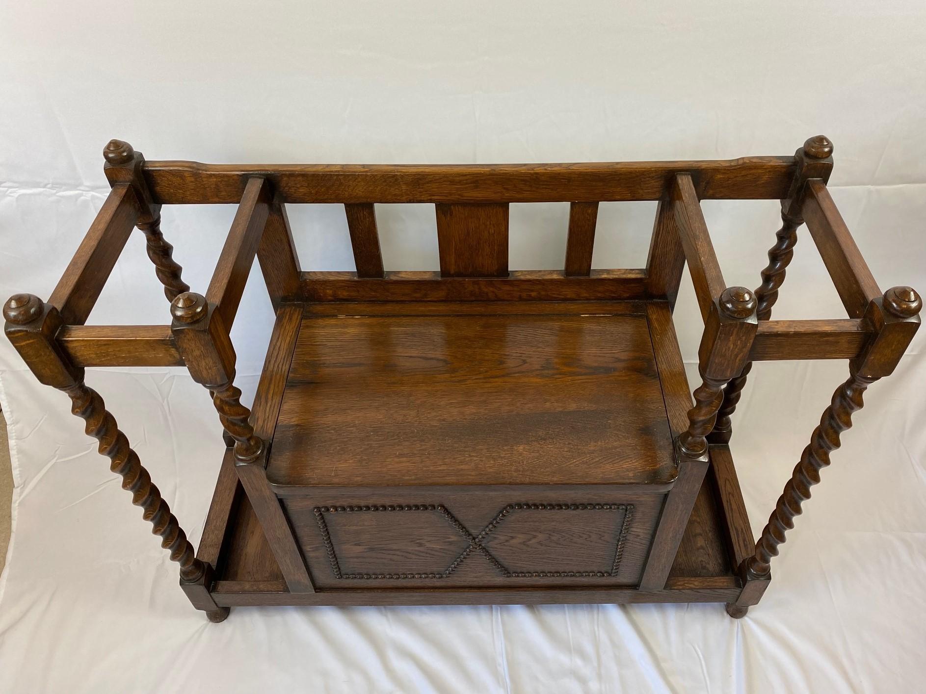 Vintage oak barley twist bench with storage. A very attractive yet highly functional bench with under-seat storage and umbrella/walking stick storage either side of the seat. Compact in size, this piece is a perfect small space storage solution.