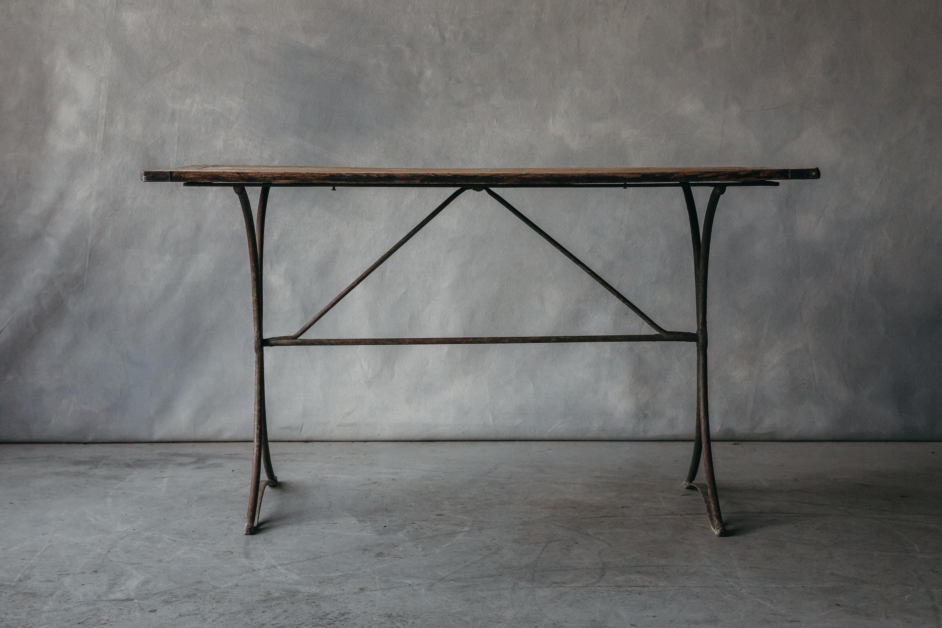 Vintage Oak Bistro Table From France, circa 1950. Solid top with iron base. Nice wear and use.