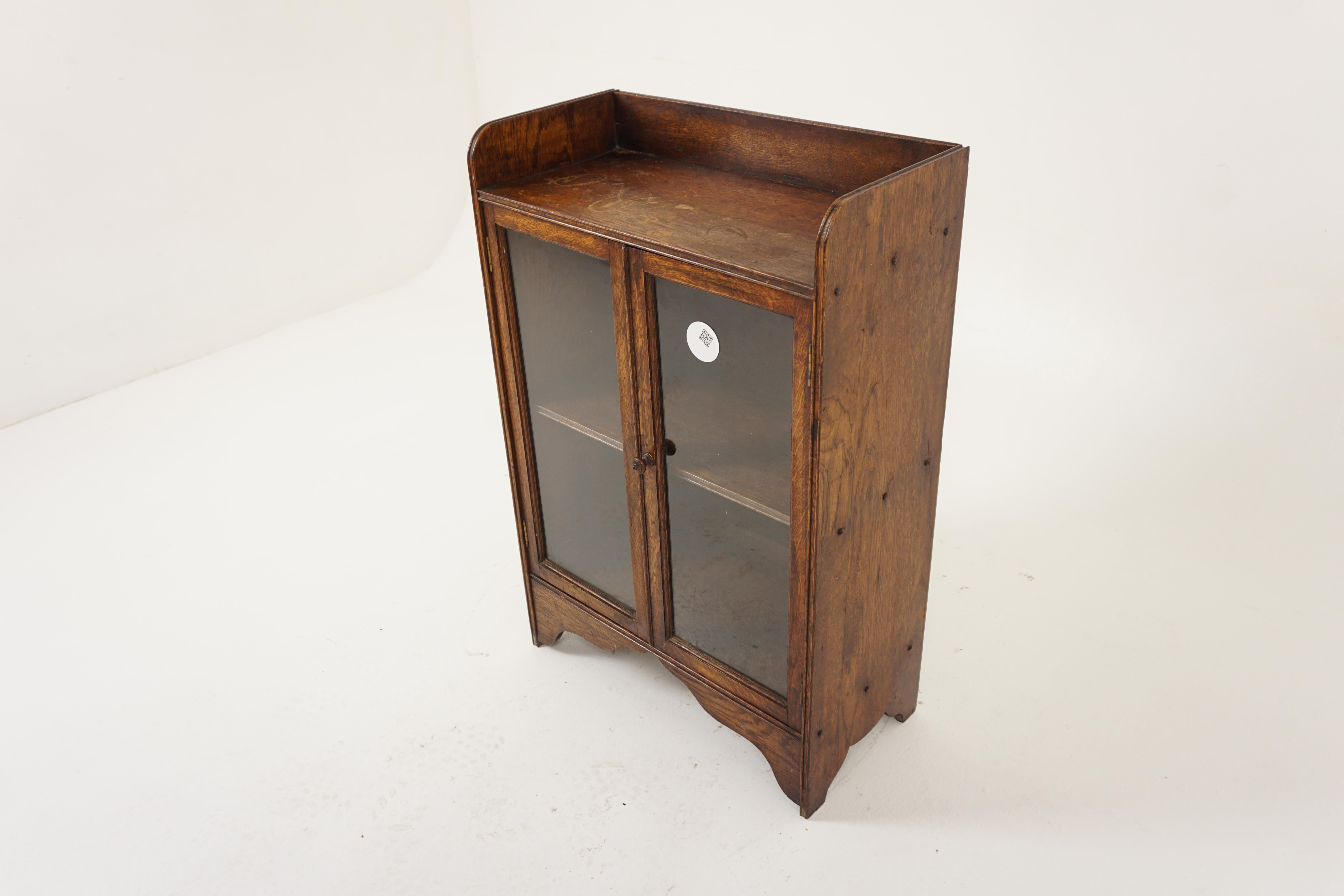 Antique Oak Bookcase, Vintage Petite Two Door Display Cabinet, Antique Furniture, Scotland 1930, H1110

+ Scotland 1930
+ Solid Oak
+ Original Finish
+ Three quarter gallery on top 
+ Pair of original glass doors
+ Opens to reveal a single