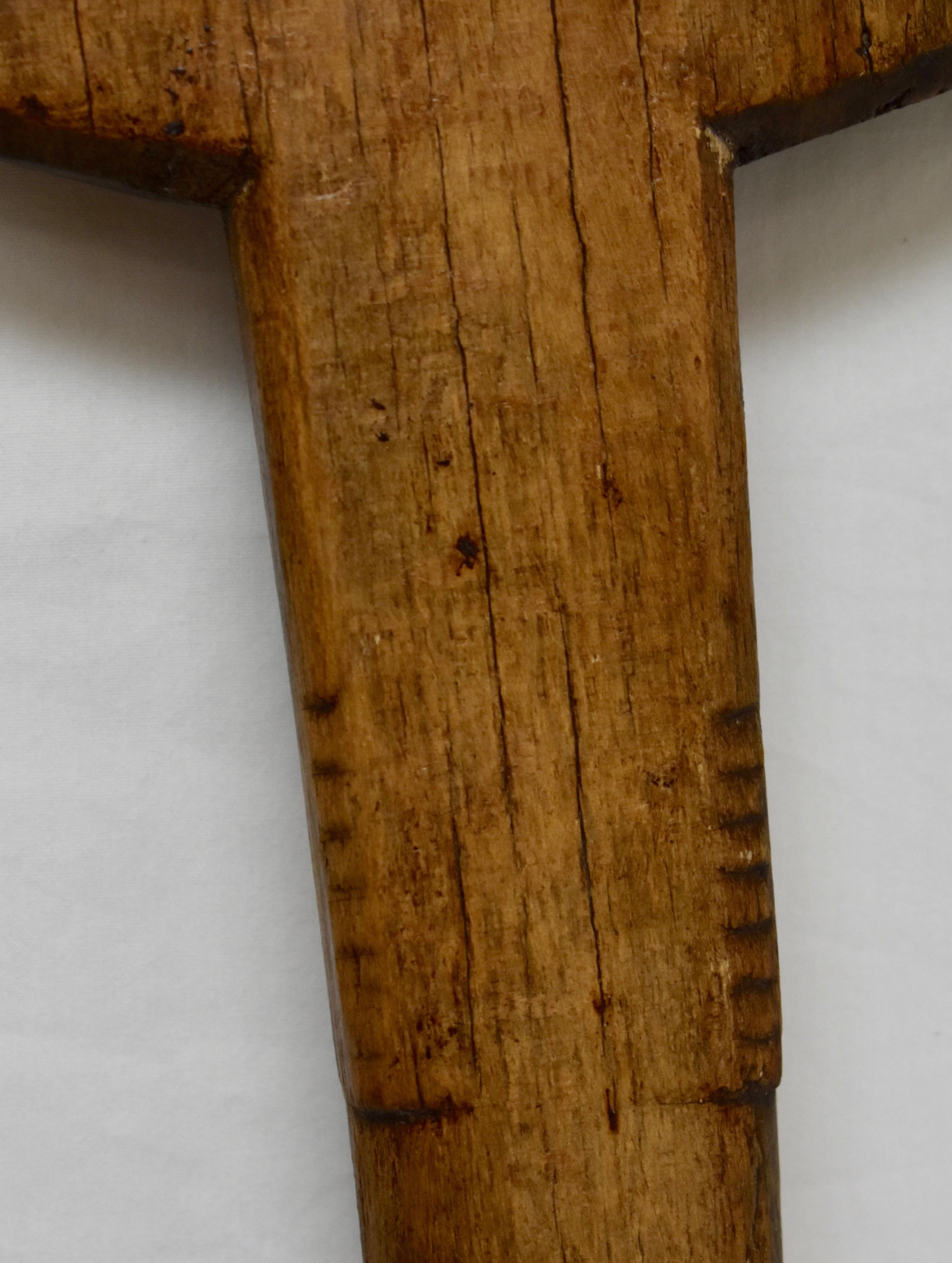 This vintage oak bread peel has been hand-carved from a single board. The long shaft is worn smooth and the paddle shows slight charring and some minor cracks to the edge.