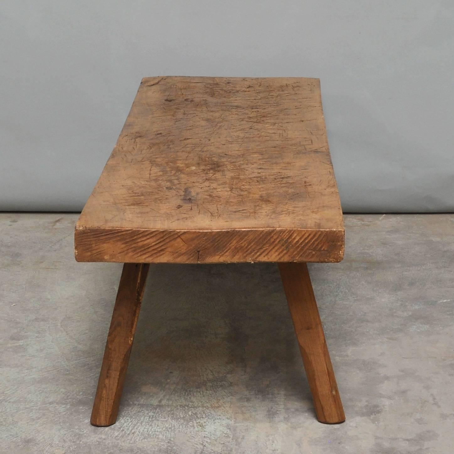 This oak butcher's block was produced in Hungary around the 1930s and has a 10 cm thick top. The piece features the original oak legs, and has been wax-finished. The legs has been cut down to a standard coffee table or bench size.