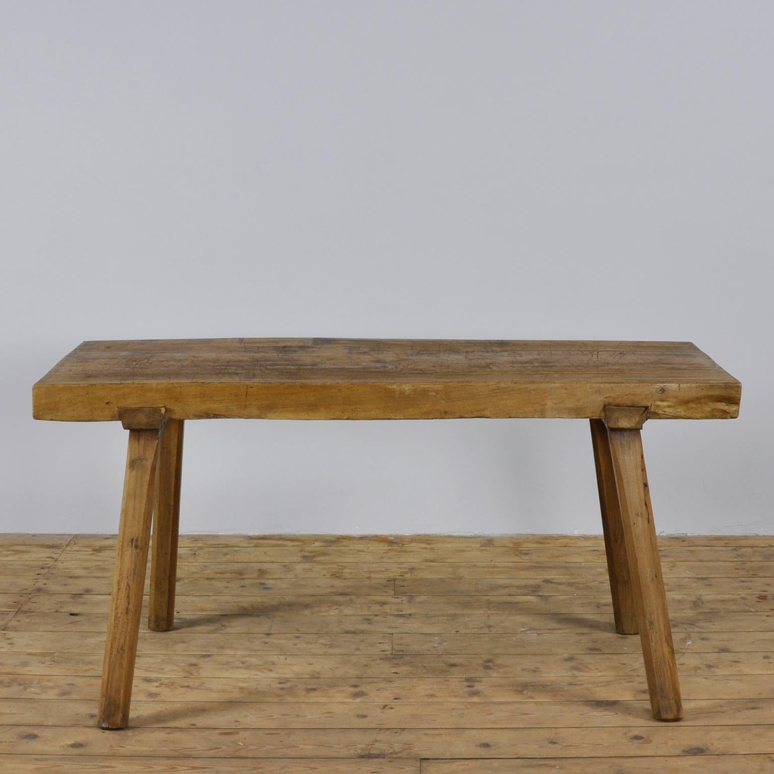 This oak butcher's farm table was produced in Hungary circa 1930s. With a nice distressed top. The top is made of a single piece of oak. This piece features the original legs and has been wax-finished.