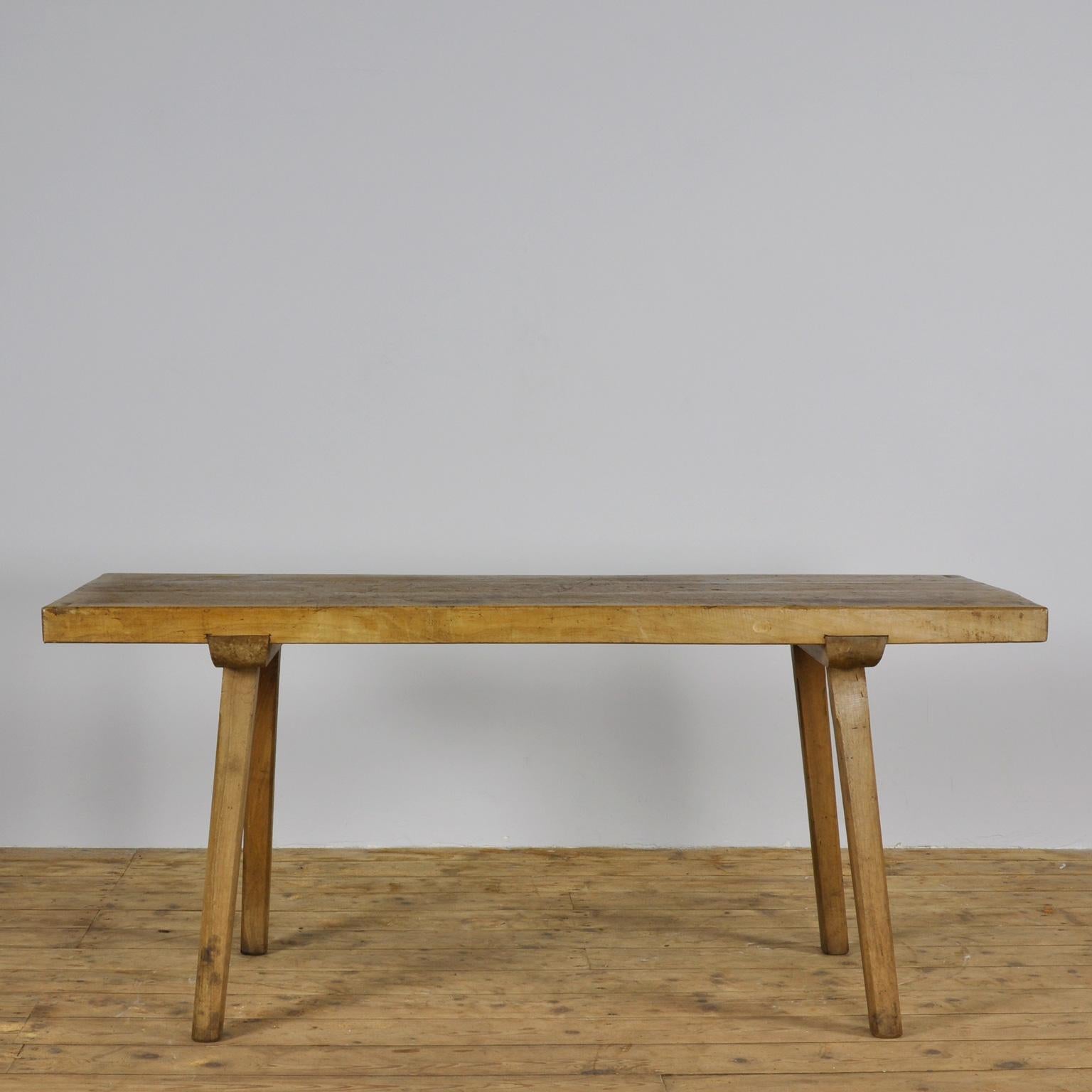This oak butcher's farm table was produced in Hungary around the 1930s. With a nice distressed top. This piece features the original legs and has been wax-finished.