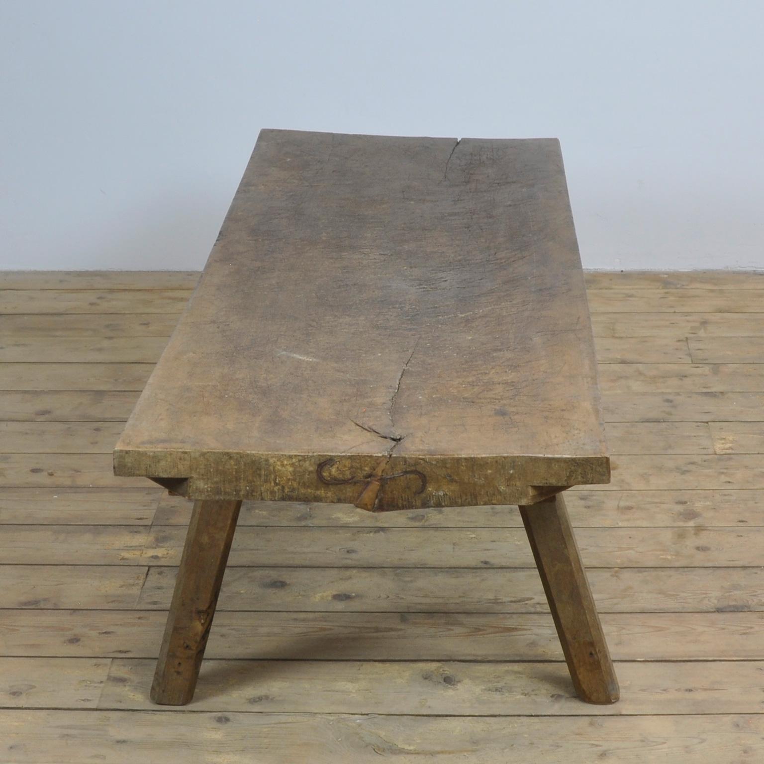 This oak butcher's table was produced in Hungary, circa 1930s and has a 7 cm thick top. The legs has been cut down to a standard coffee table or bench size.