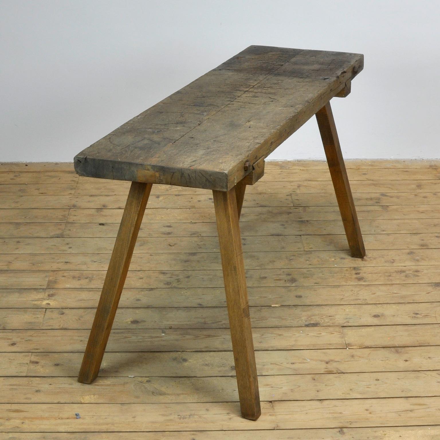 This oak butcher's farm table was produced in Hungary, circa 1930s. With a nice distressed oak top of 6.5 cm thick. This piece has been wax-finished. Treated for woodworm.