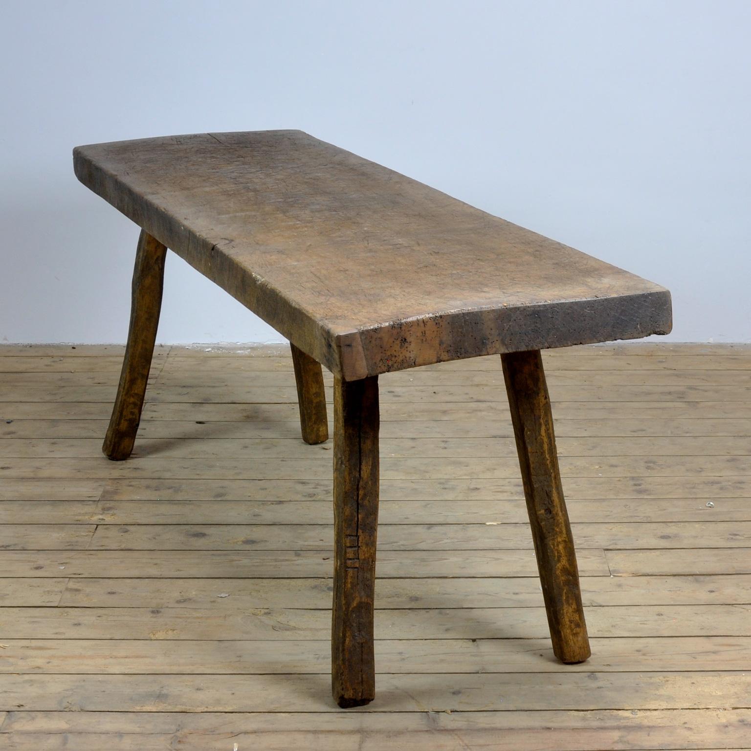 This oak butcher's farm table was produced in Hungary, circa 1930s. With a nice distressed oak top of 7.5 cm thick made out of one single piece of oak. It has its original legs witch are marked by the maker (I to IIII) This piece has been