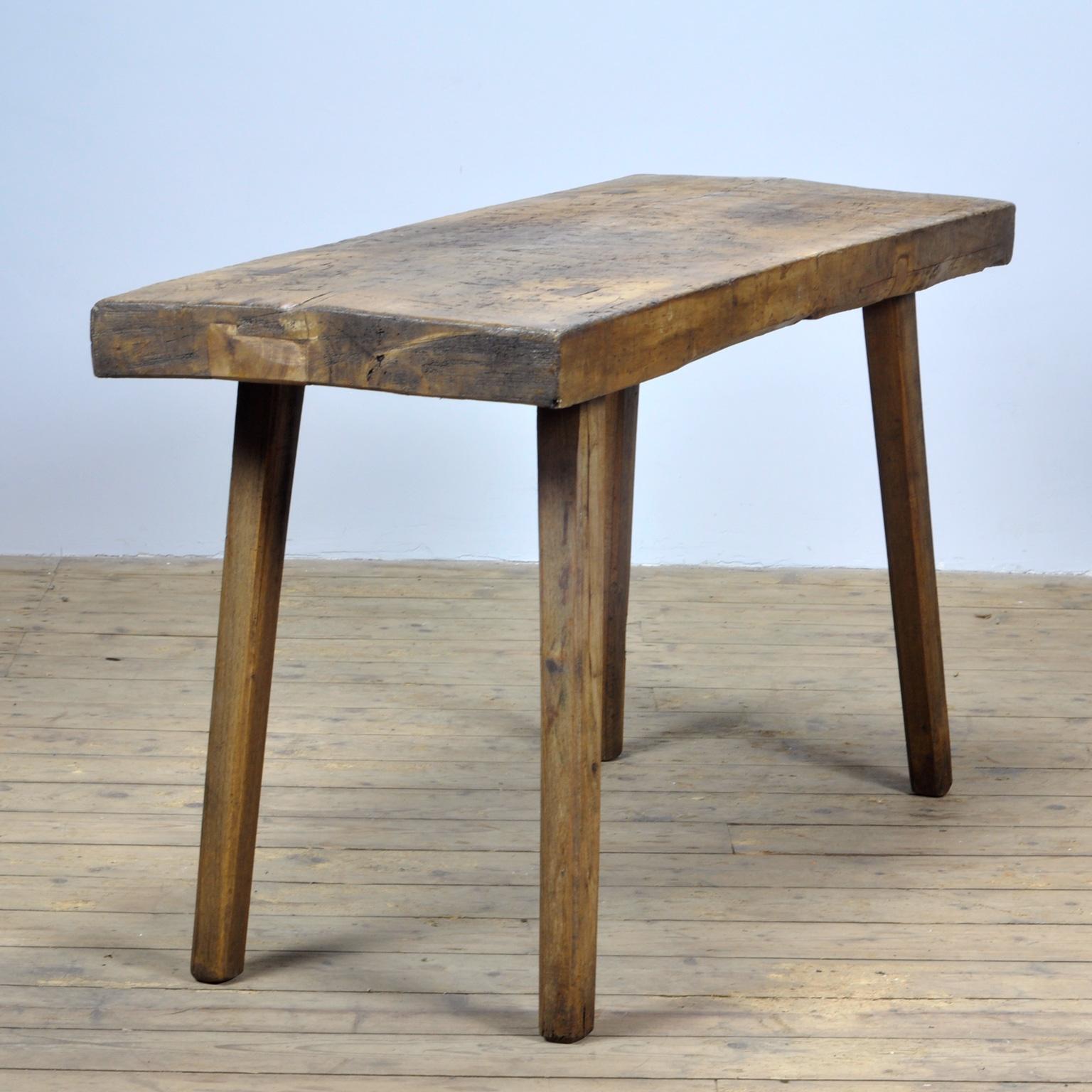 This oak butcher's farm table was produced in Hungary, circa 1930s. With a nice distressed oak top of 9 cm thick. This piece has been wax-finished. Treated for woodworm.