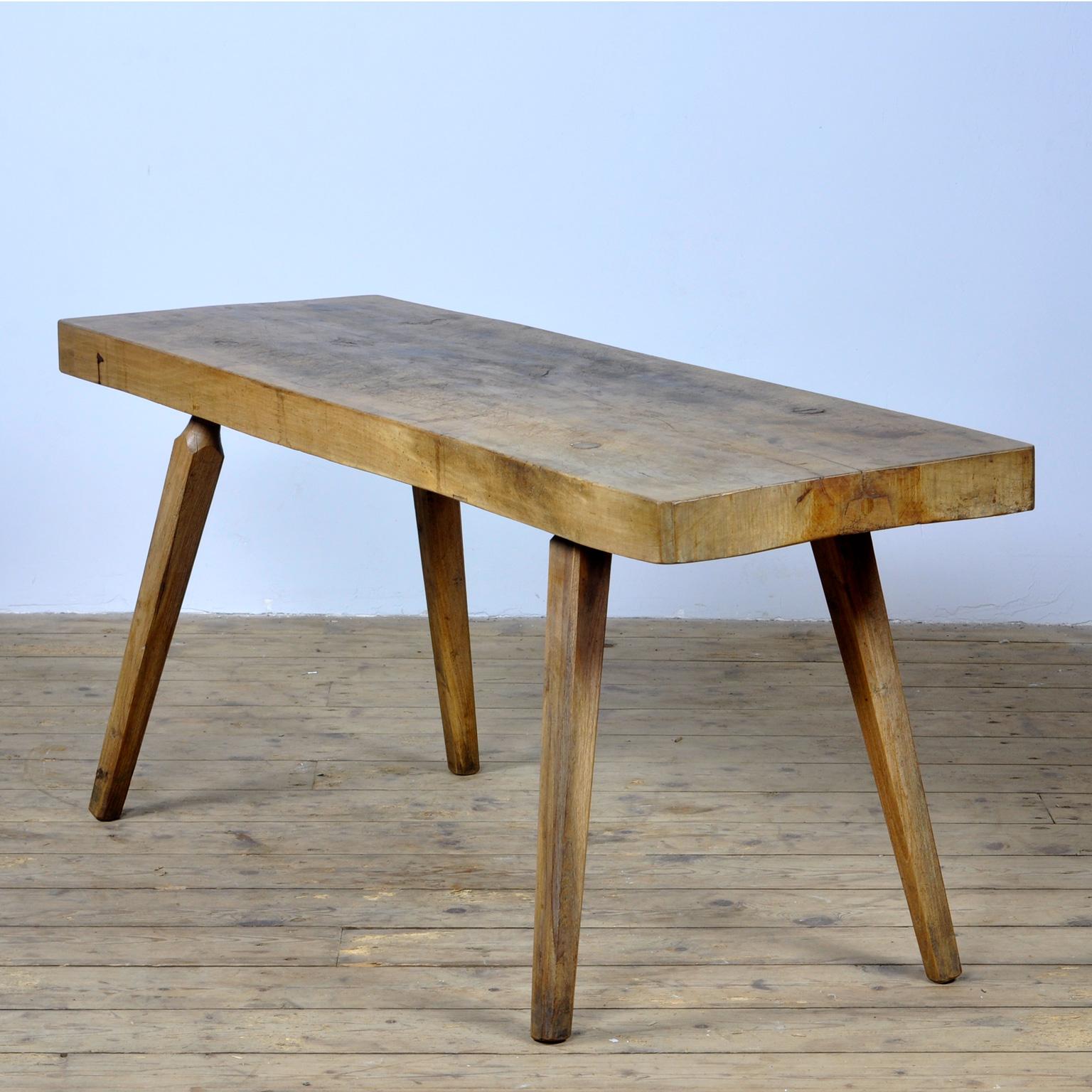 This oak butcher's farm table was produced in Hungary circa 1930s. With a nice distressed oak top of 8 cm thick. This piece has been wax-finished. Treated for woodworm.