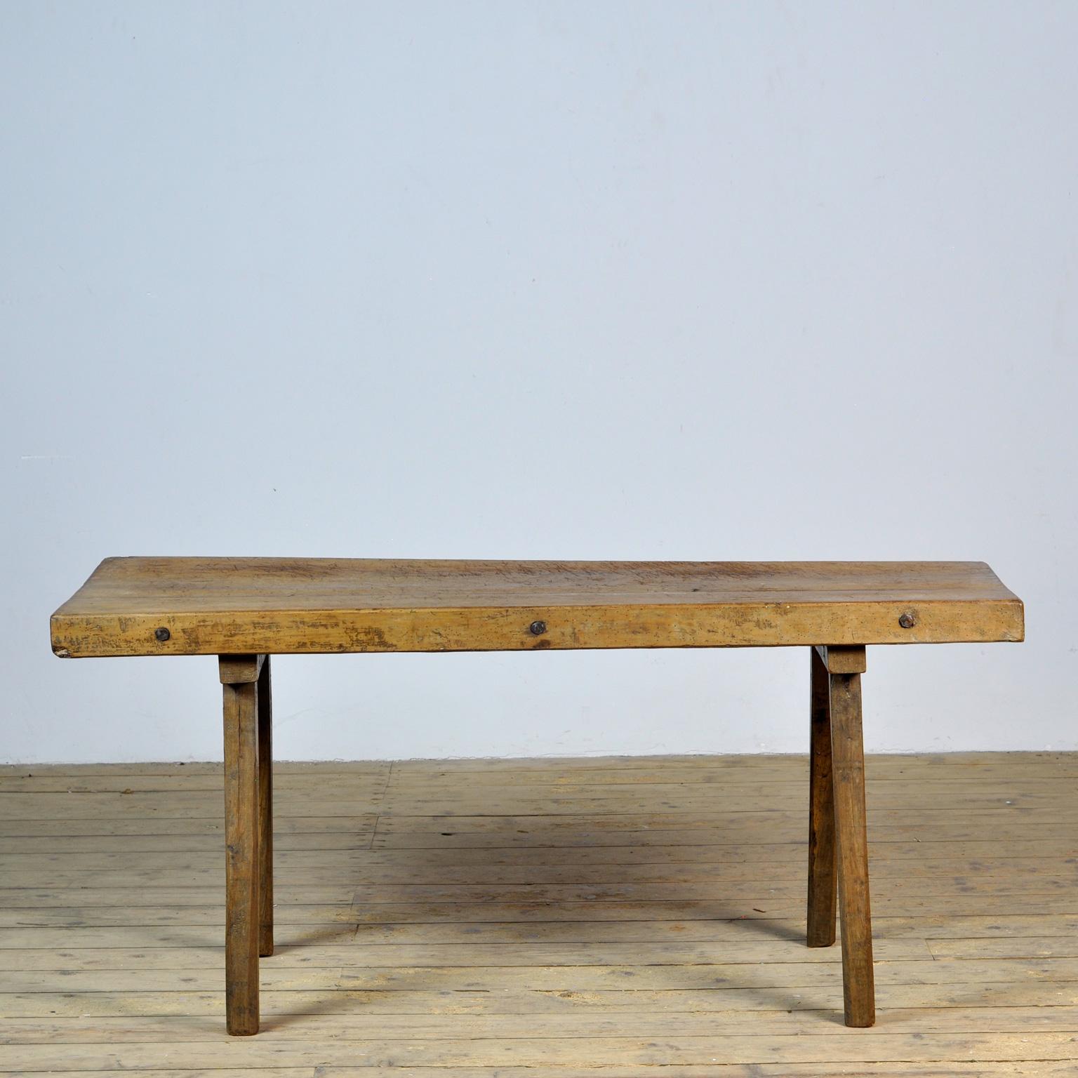 This oak butcher's farm table was produced in Hungary around the 1930s. With a nice distressed oak top of 7 cm thick. The legs/top are numbered by the maker. This piece has been wax-finished. Treated for woodworm.