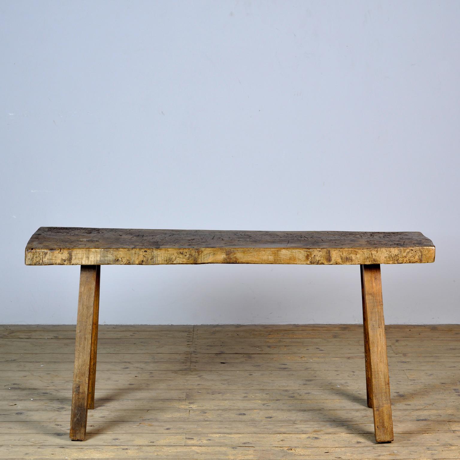 This oak butcher's farm table was produced in Hungary around the 1930s. With a nice distressed oak top of 7 cm thick. This piece has been wax-finished. Treated for woodworm.