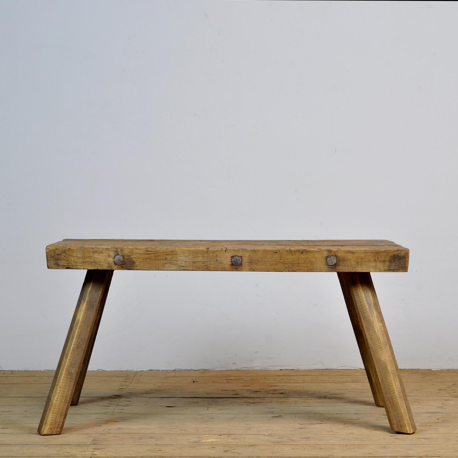 This oak butcher's farm table was produced in Hungary around the 1930s. With an oak top of 6 cm thick. The legs are shortened to the ideal height for a coffee table or bench. Treated for woodworm.