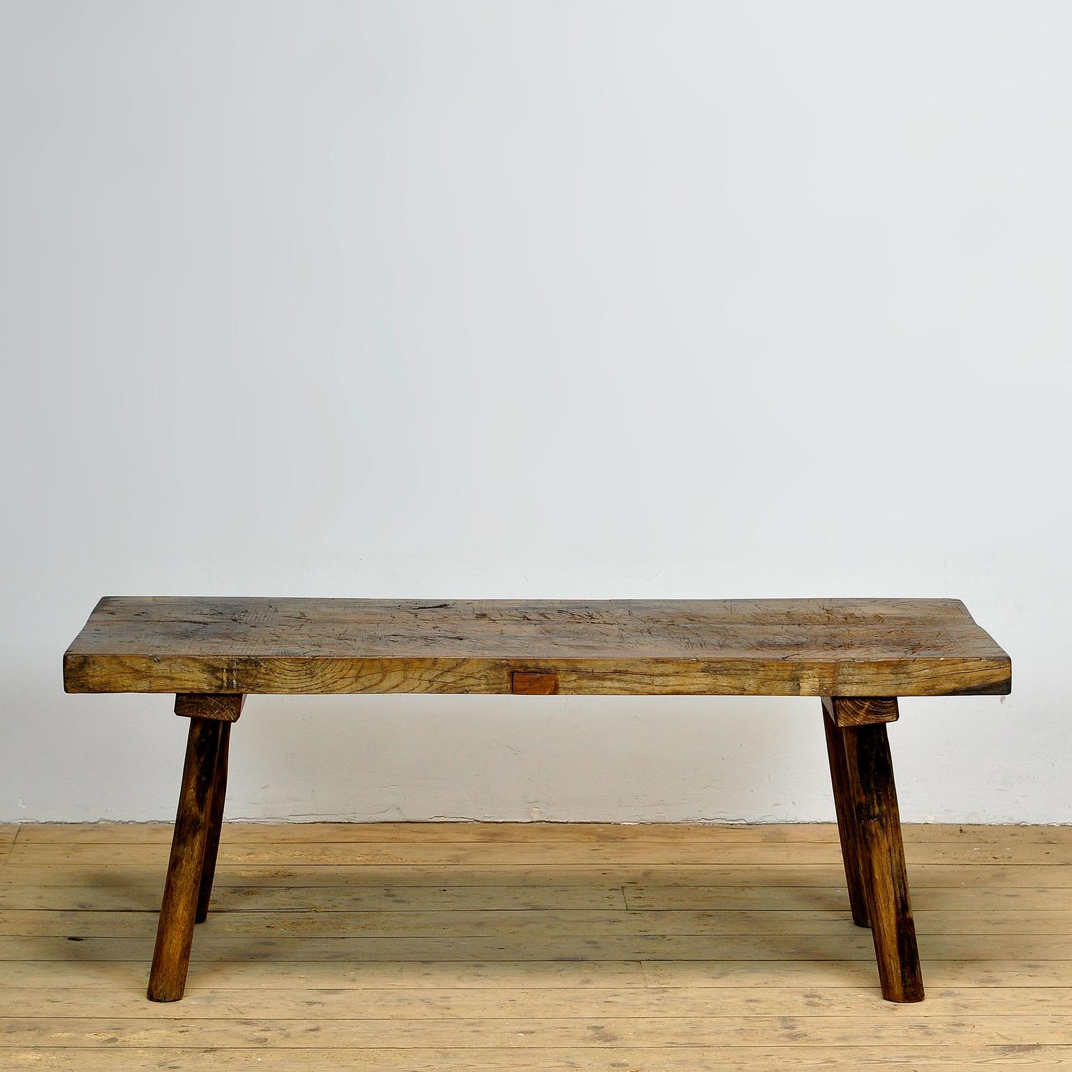 This oak butcher's farm table was produced in hungary around the 1930s. With an oak top of 5 cm thick. The legs are shortened to the ideal height for a coffee table or bench. Treated for woodworm. 