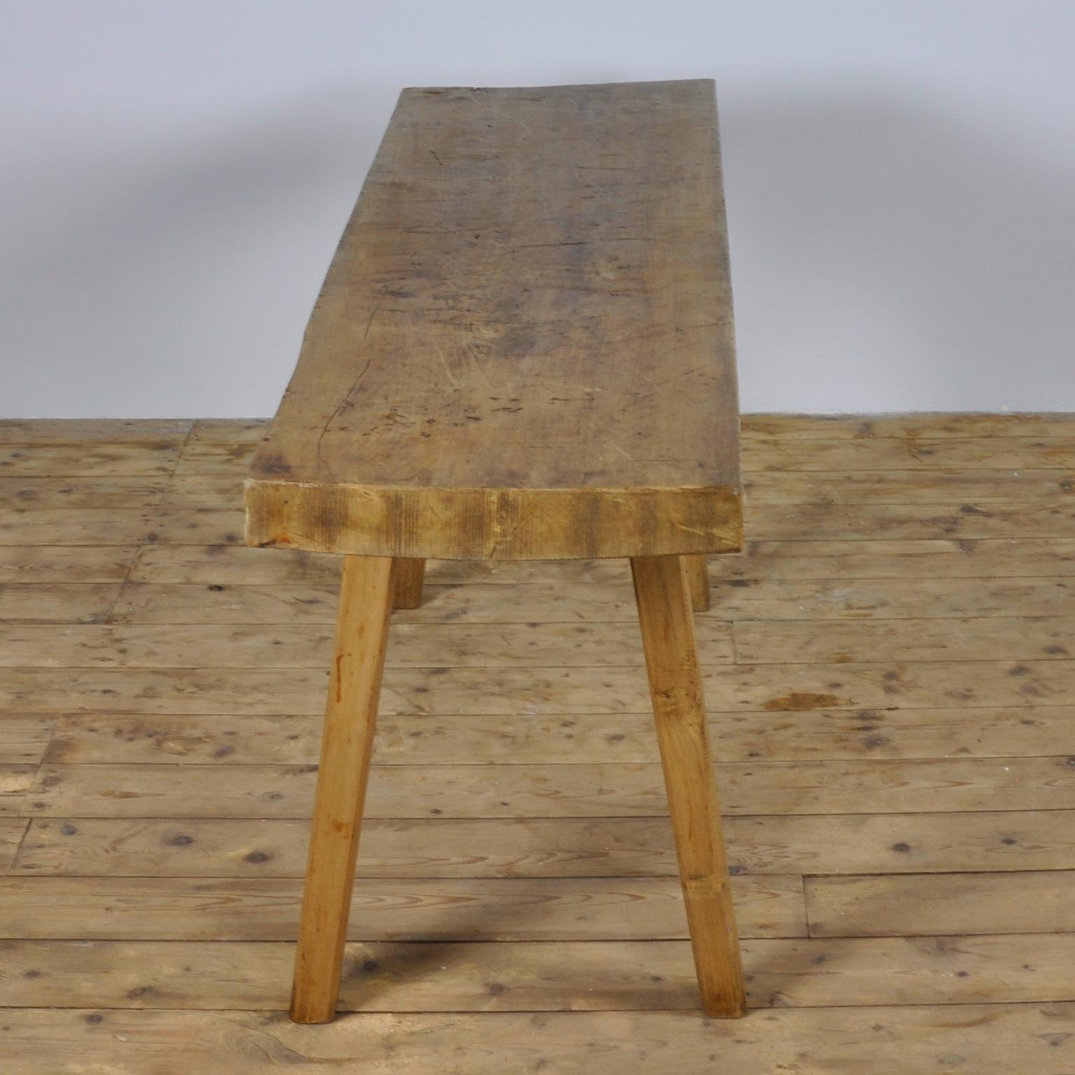 This butcher's table was produced in Hungary circa 1930s and has a 10 cm thick top. The piece features the original legs and has been wax-finished.