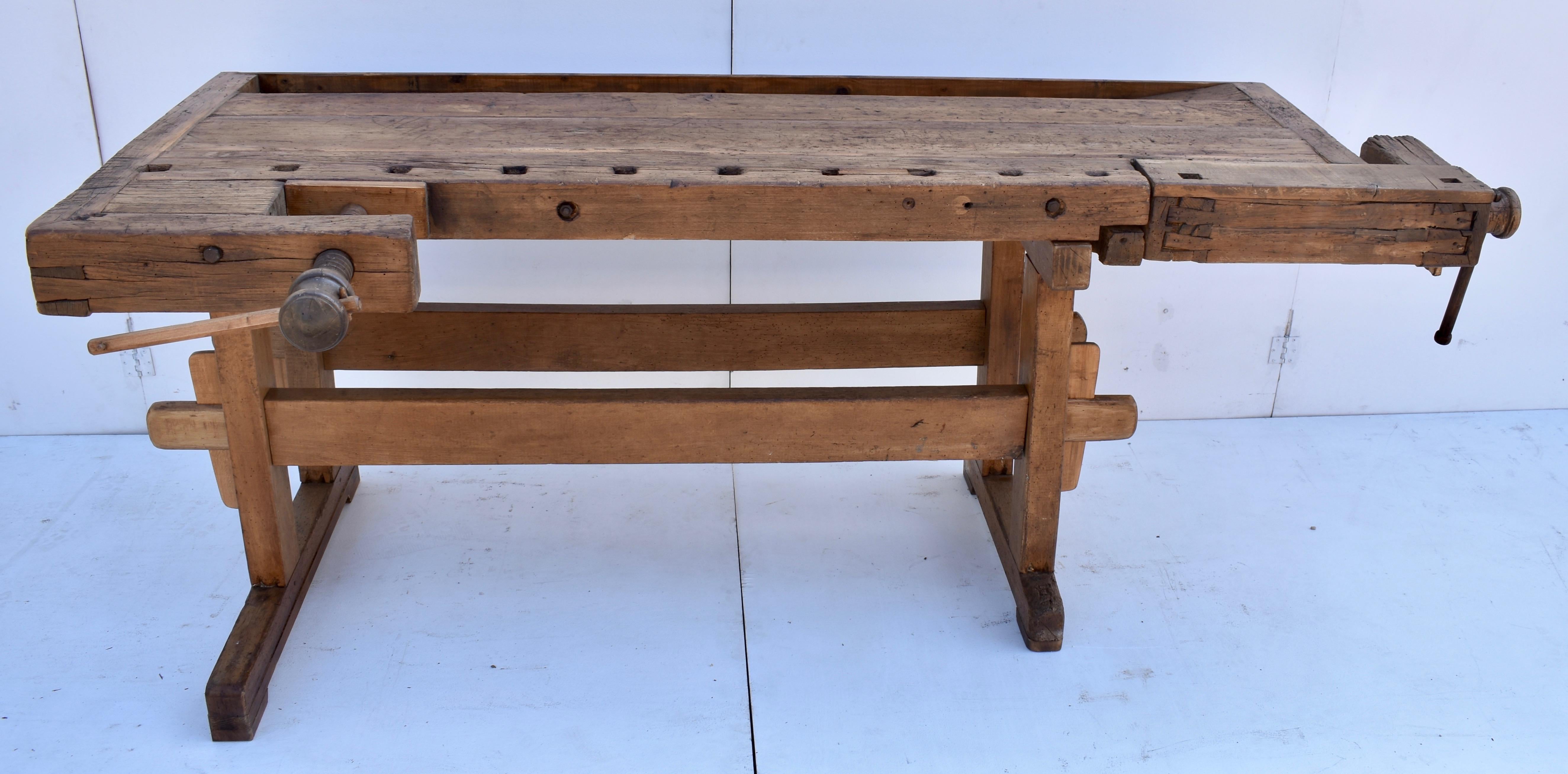 This joiner’s work bench is well-used but still in great super-sturdy condition without too much distress on the surface. The trestle-style base is made entirely of oak. The uprights are 4”x3”, hand-cut, through-tenoned and pegged top and bottom to