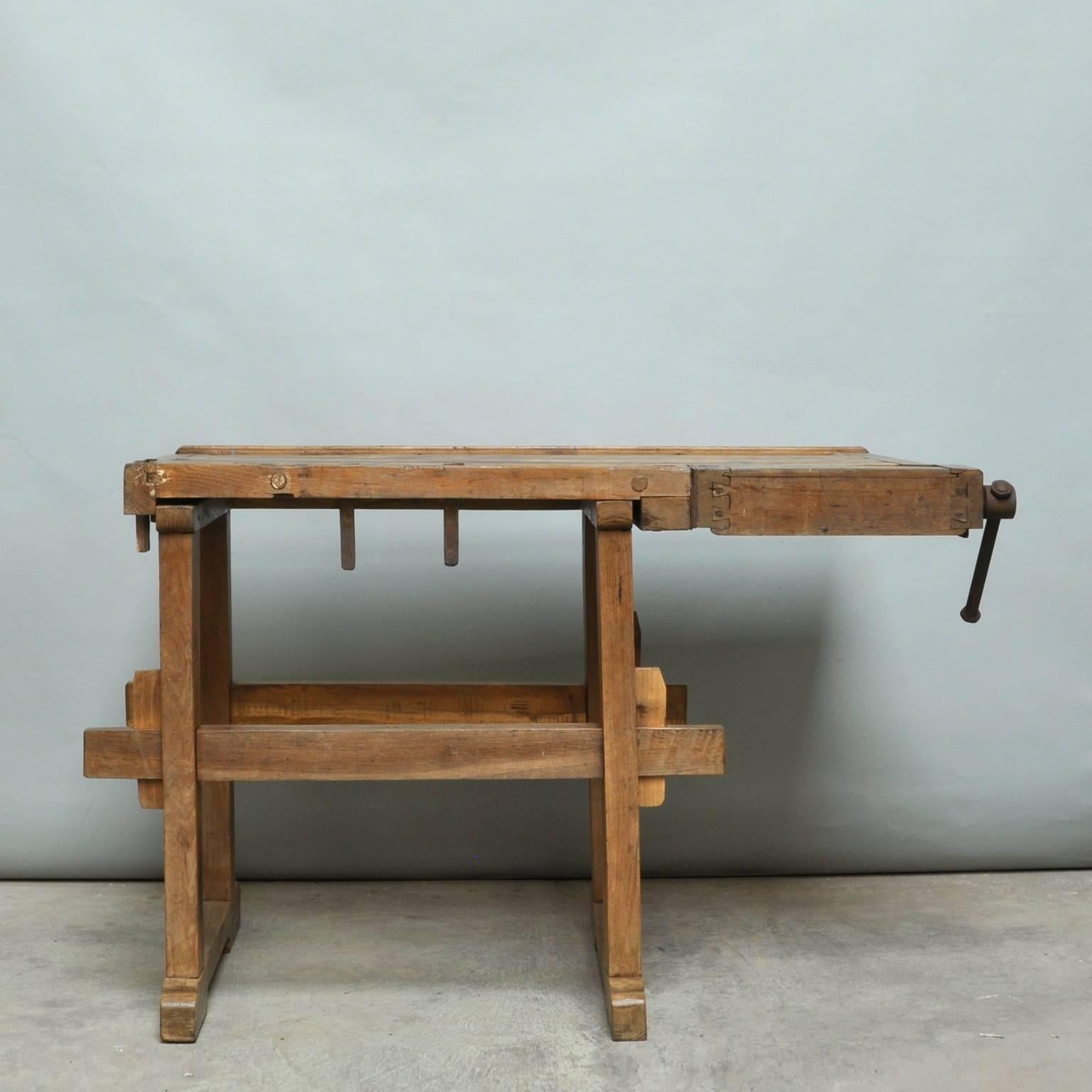 This vintage Hungarian carpenter’s workbench features one iron vice and a recessed tray where the carpenter would lay his tools. It was manufactured, circa 1935.