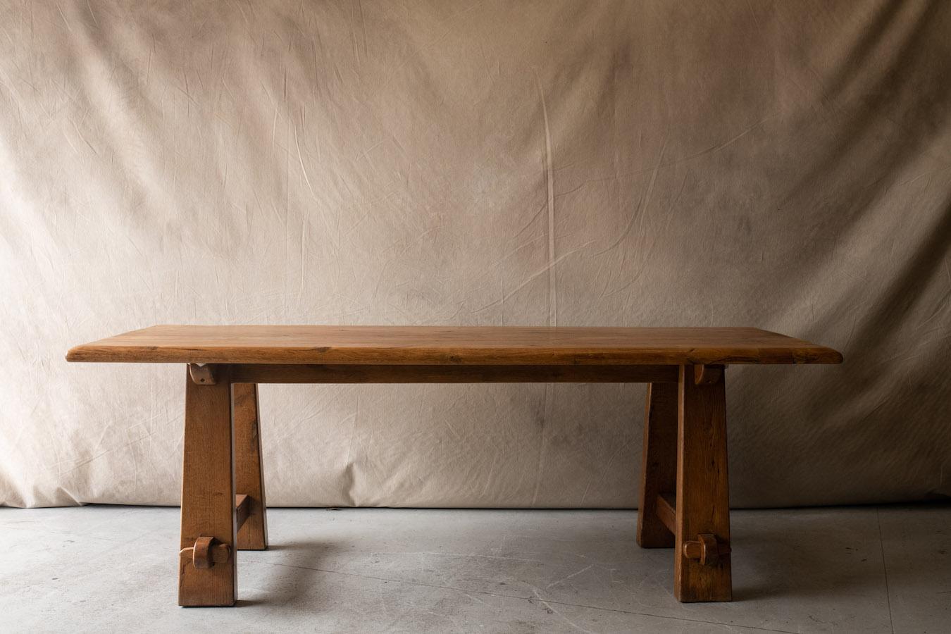 Vintage mid century dining table in stained oak from France, Circa 1950.  Solid oak construction with flared legs and wooden peg joints.  Nice even patina and use.

We don't have the time to write an extensive description on each of our pieces. We