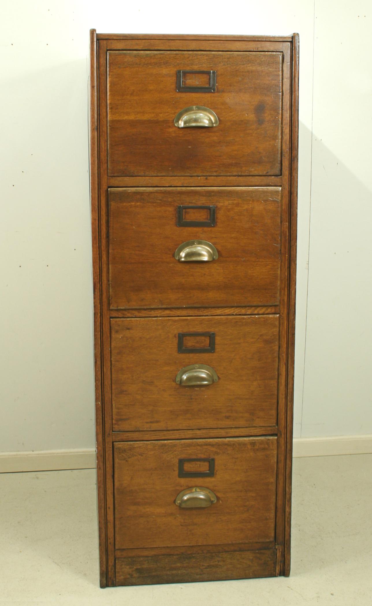 A high quality solid oak filing cabinet made by the Office Furniture Company. The cabinet has four drawers with brassed handles and the original card holders. It bears the makers trade label to the side which reads 'Office Furniture Co., 184