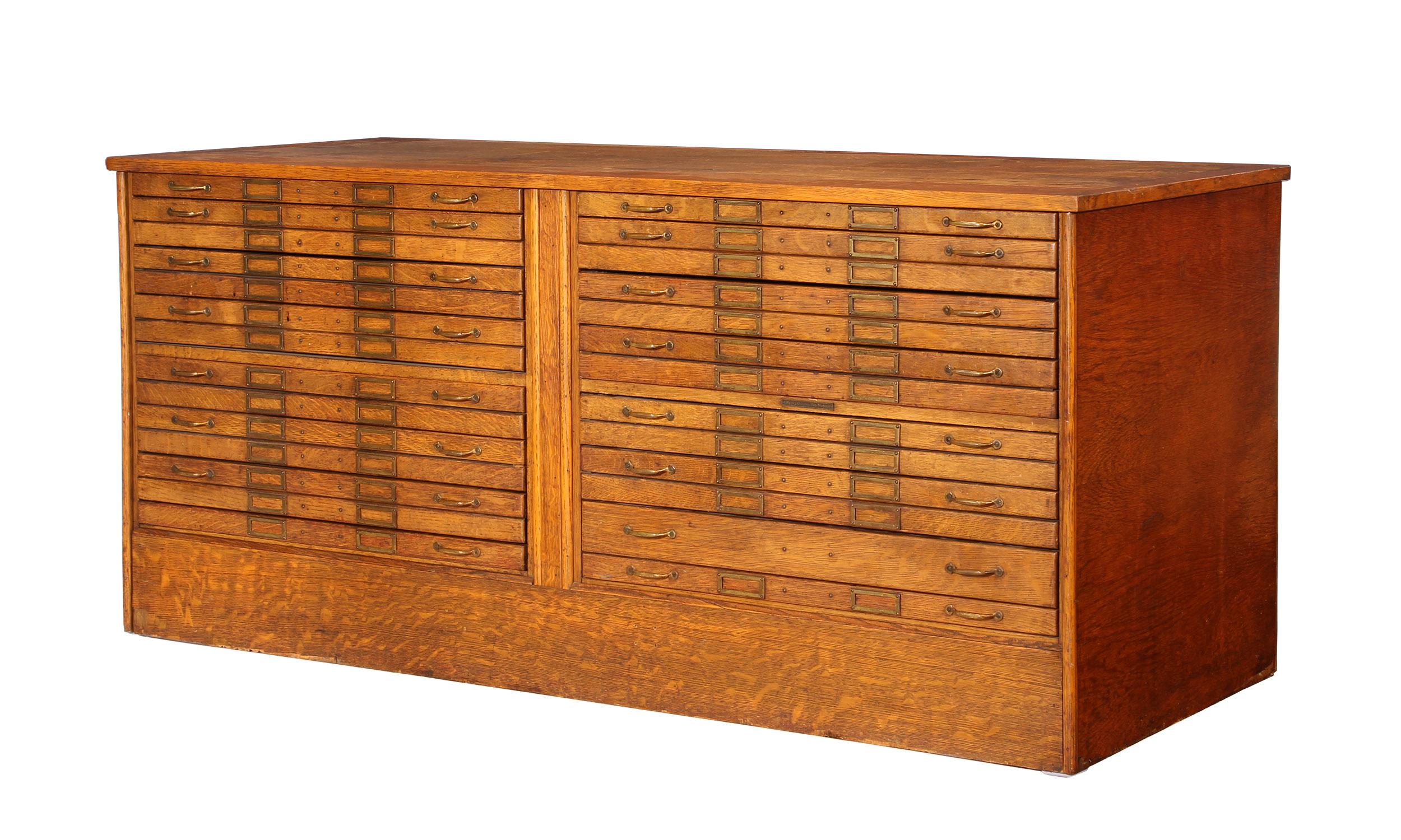 Vintage oak flat-file storage cabinet made by Library Bureau SoleMakers. Finished all the way around, features brass hardware. Top and bottom drawers are black hardboard, the rest are grey felt. Measures 67