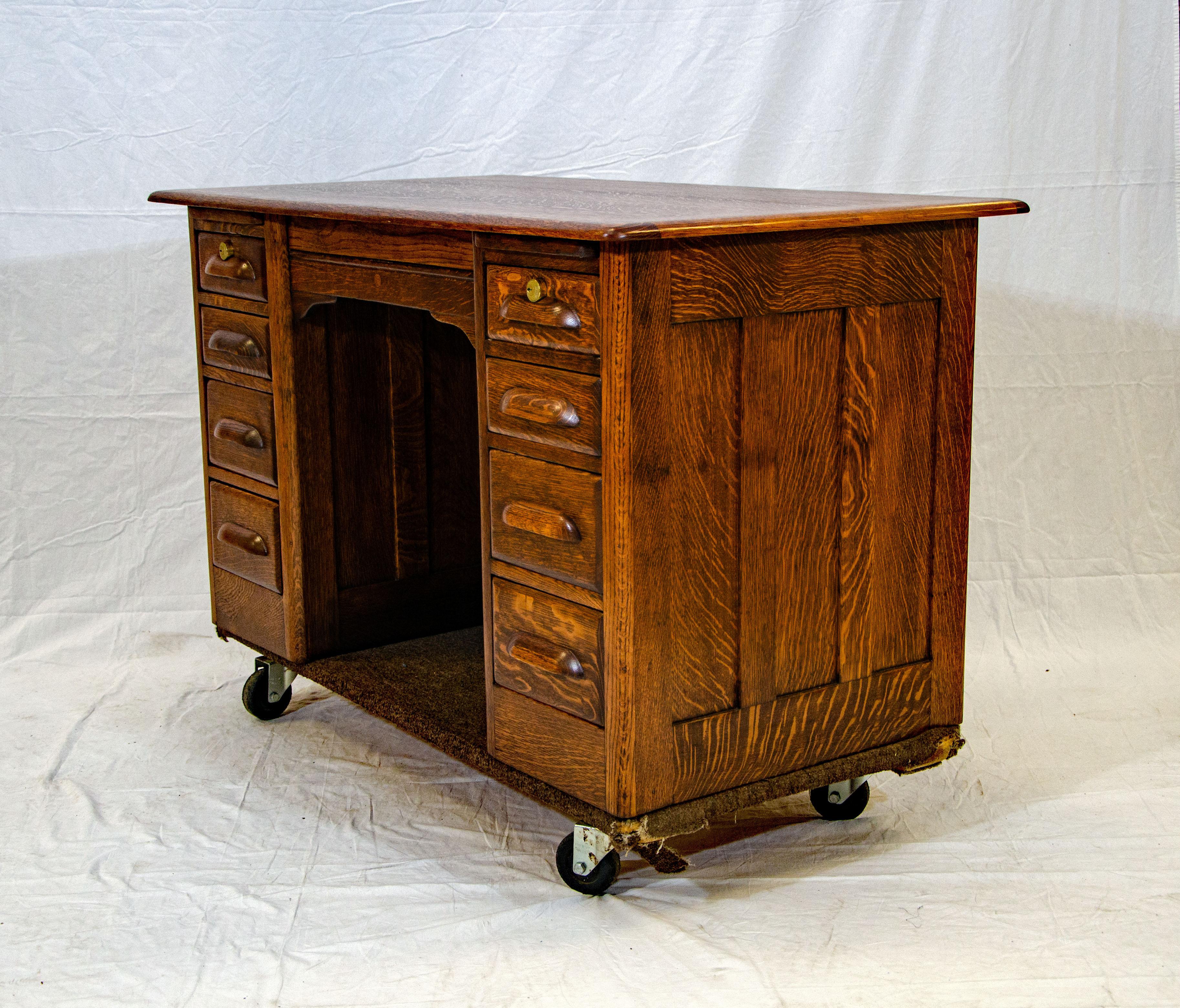 This smaller size antique oak pedestal desk is finished on all sides and can be placed in the center of a room. The chair space is 20 1/2