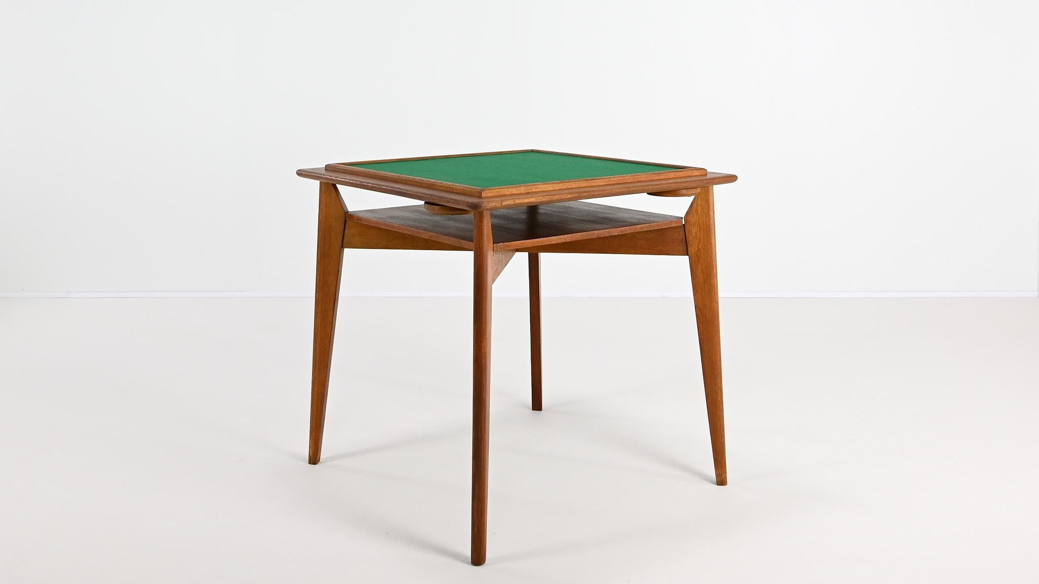 Vintage oak game table, France C.1950

Very nice and unusual game table, with reversible top and four articulated cup holders, made of oak and oak veneer. In the manner of Marcel Gascoin or Roger Landault.

The table is in its original condition,