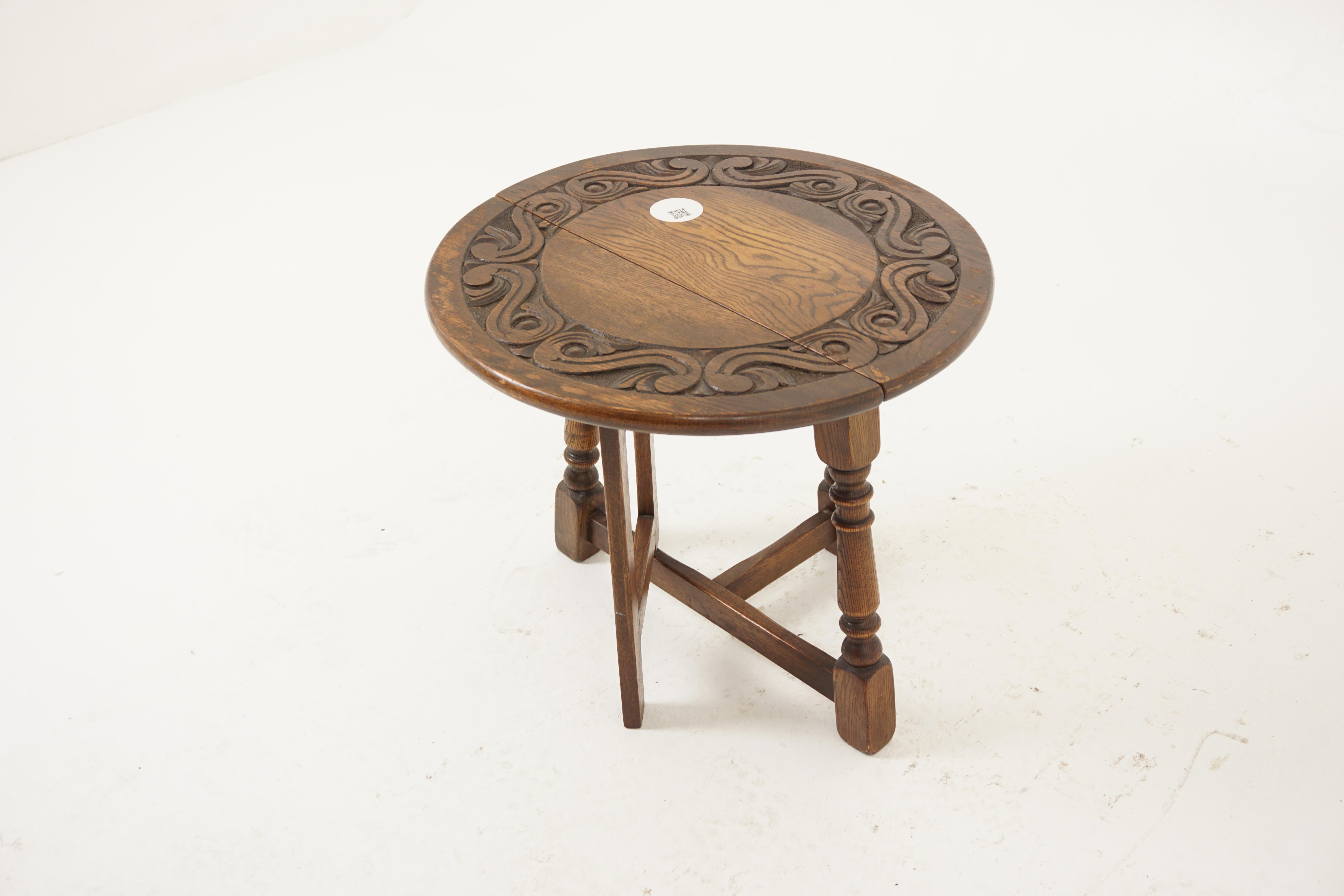Antique Oak Gateleg, Petite Carved Circular Drop Leaf Table, Antique Furniture, Scotland 1930, H1097

+ Scotland 1930
+ Solid Oak
+ Original Finish
+ Deep carved circular top
+ Standing on three turned legs
+ Joined by stretchers
+ Drop leaf on one