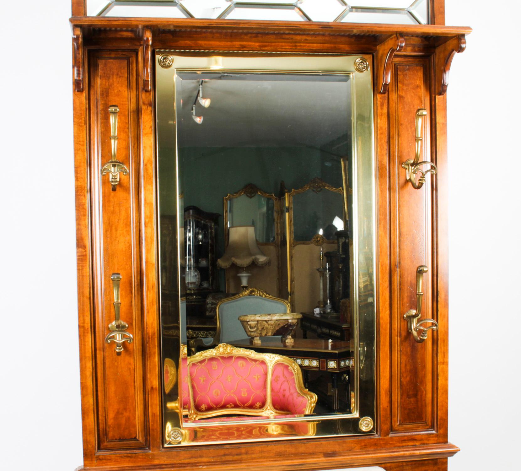 This is a stylish Victorian Revival oak hall stand, mid 20th century in date.

The hallstand features an inset bevelled mirror back with brass hooks above a marble top and drawer.

There is ample space to accommodate your coats, umbrellas and