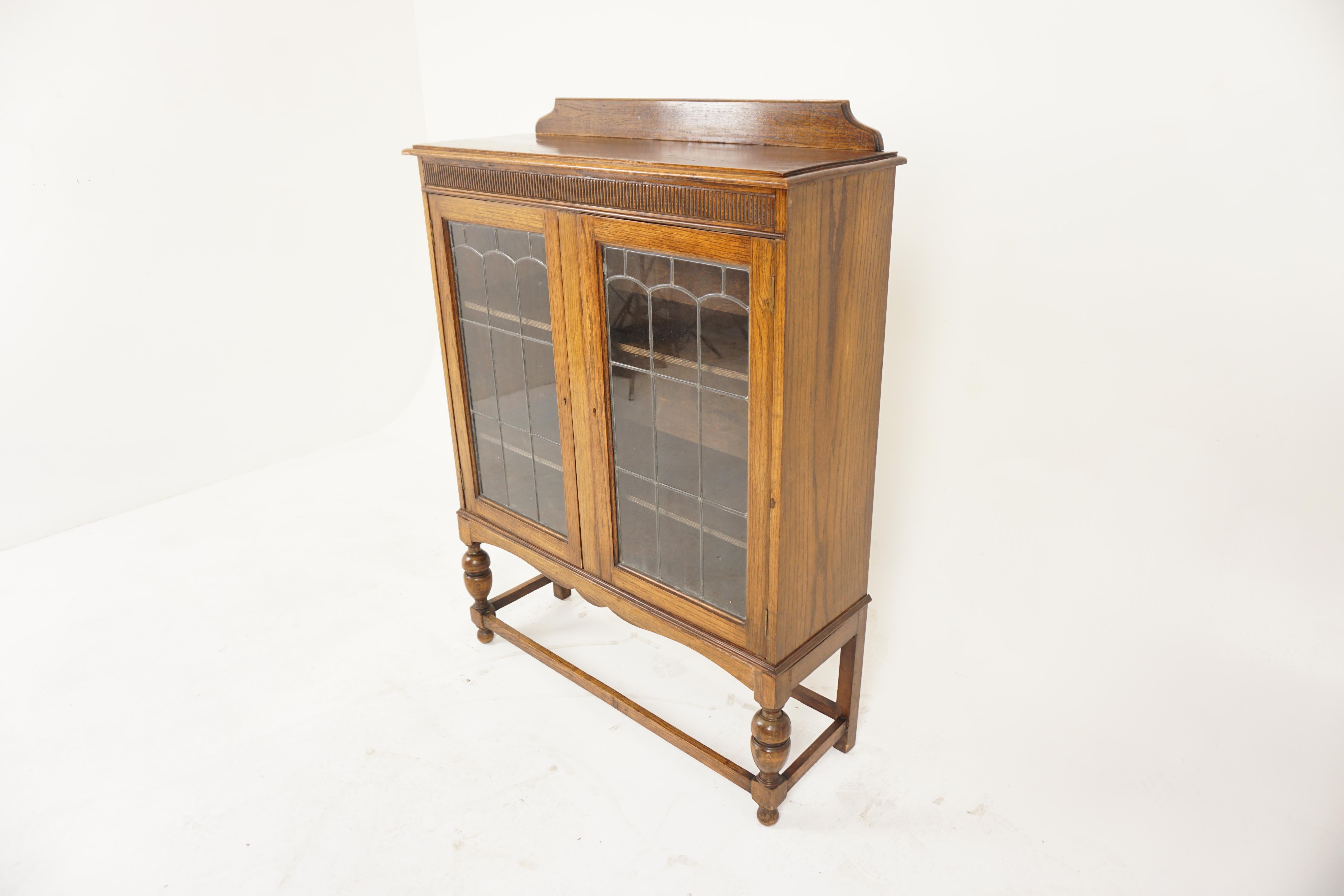 Vintage Oak Leaded Glass Bookcase, Display Cabinet, Scotland 1920, H1018

Solid Oak
Original finish
Rectangular moulded top with pediment on the back
Dentil frieze underneath
Below a pair of original leaded glass doors open to reveal a pair of