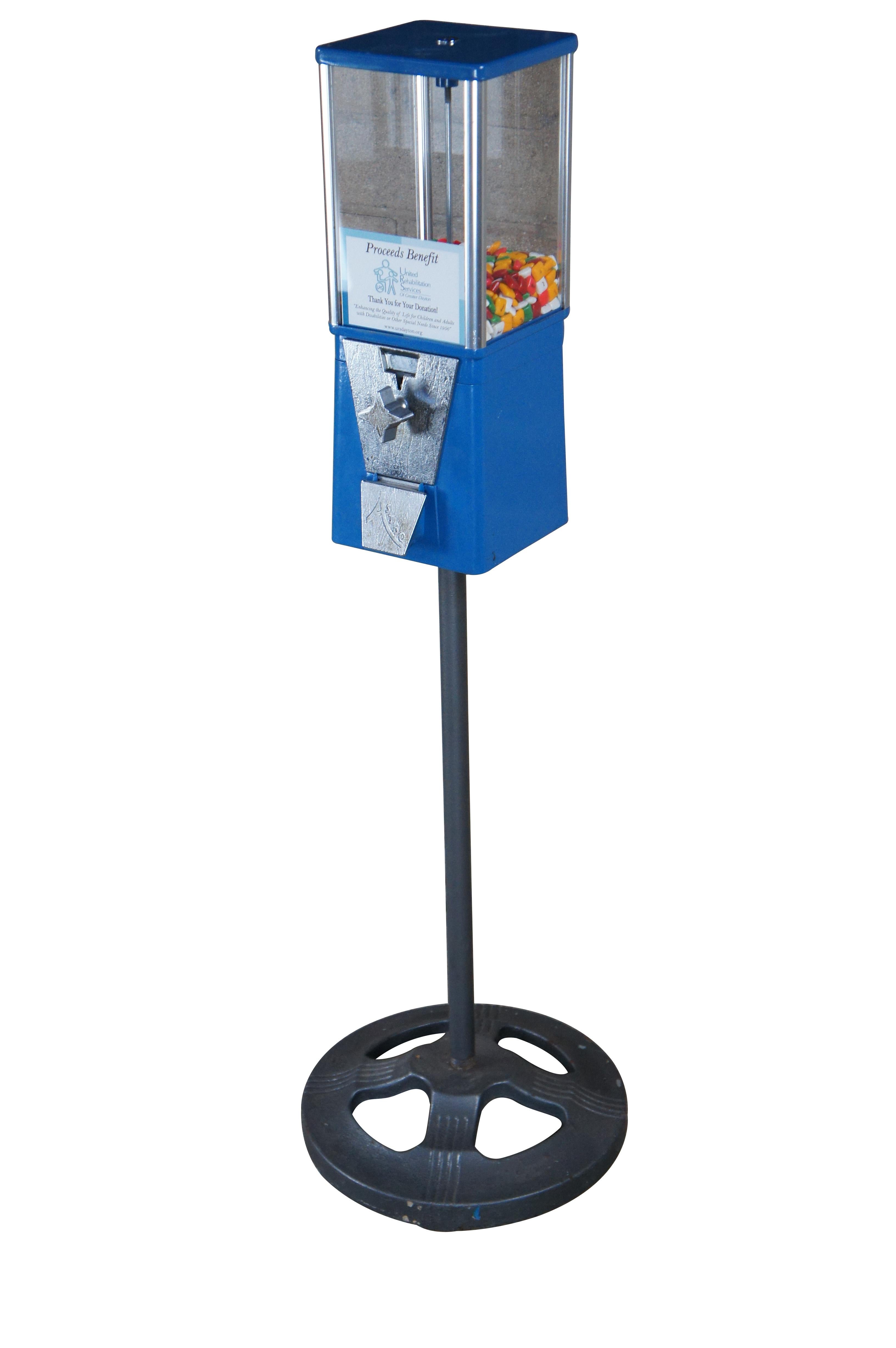 Oak Manufacturing Company Astro Gumball / Candy Machine.  Features a blue metal coin operated top over a cast iron base.  

Dimensions:
7