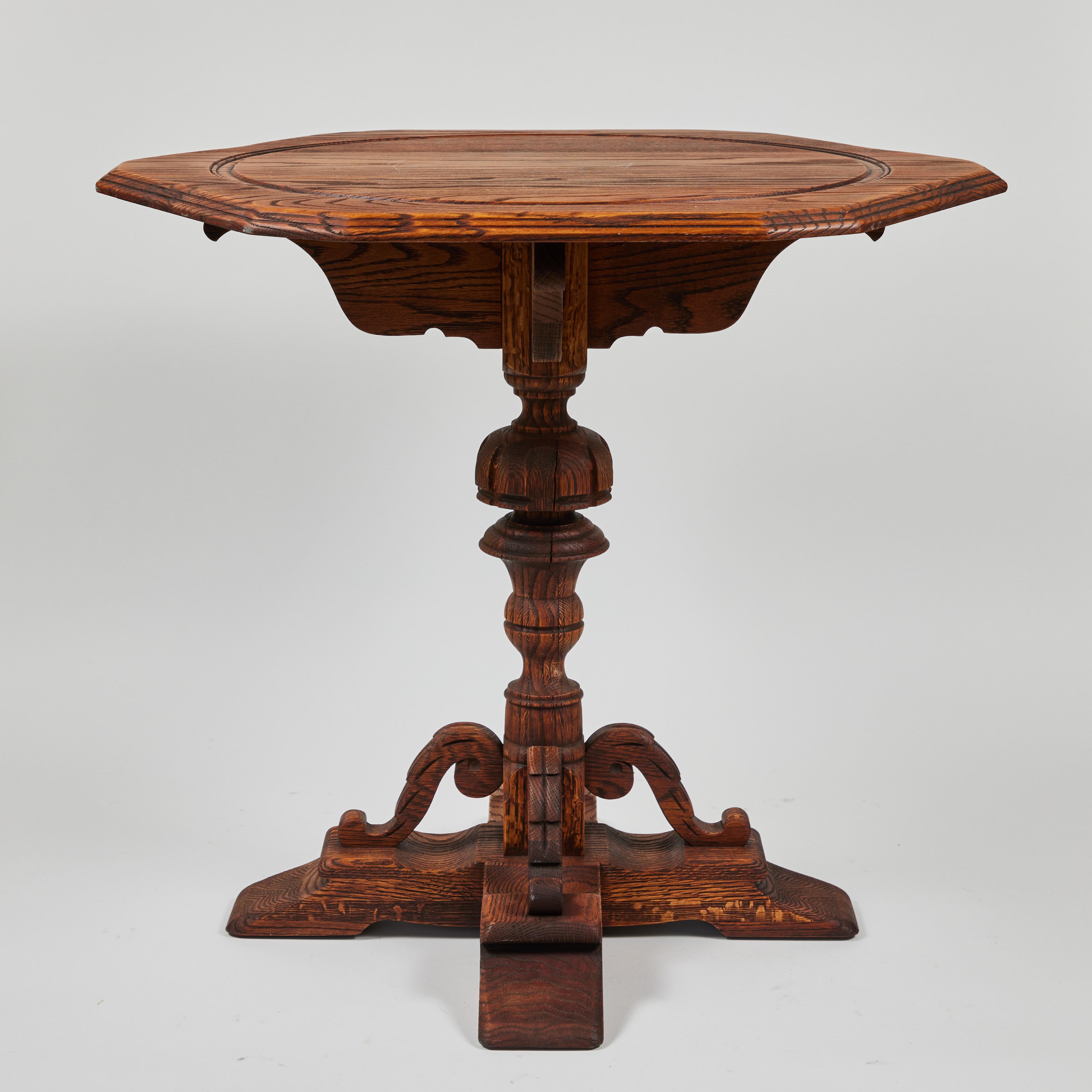 Vintage oak pedestal table with hand carved base with a raw, natural wood oil finish.