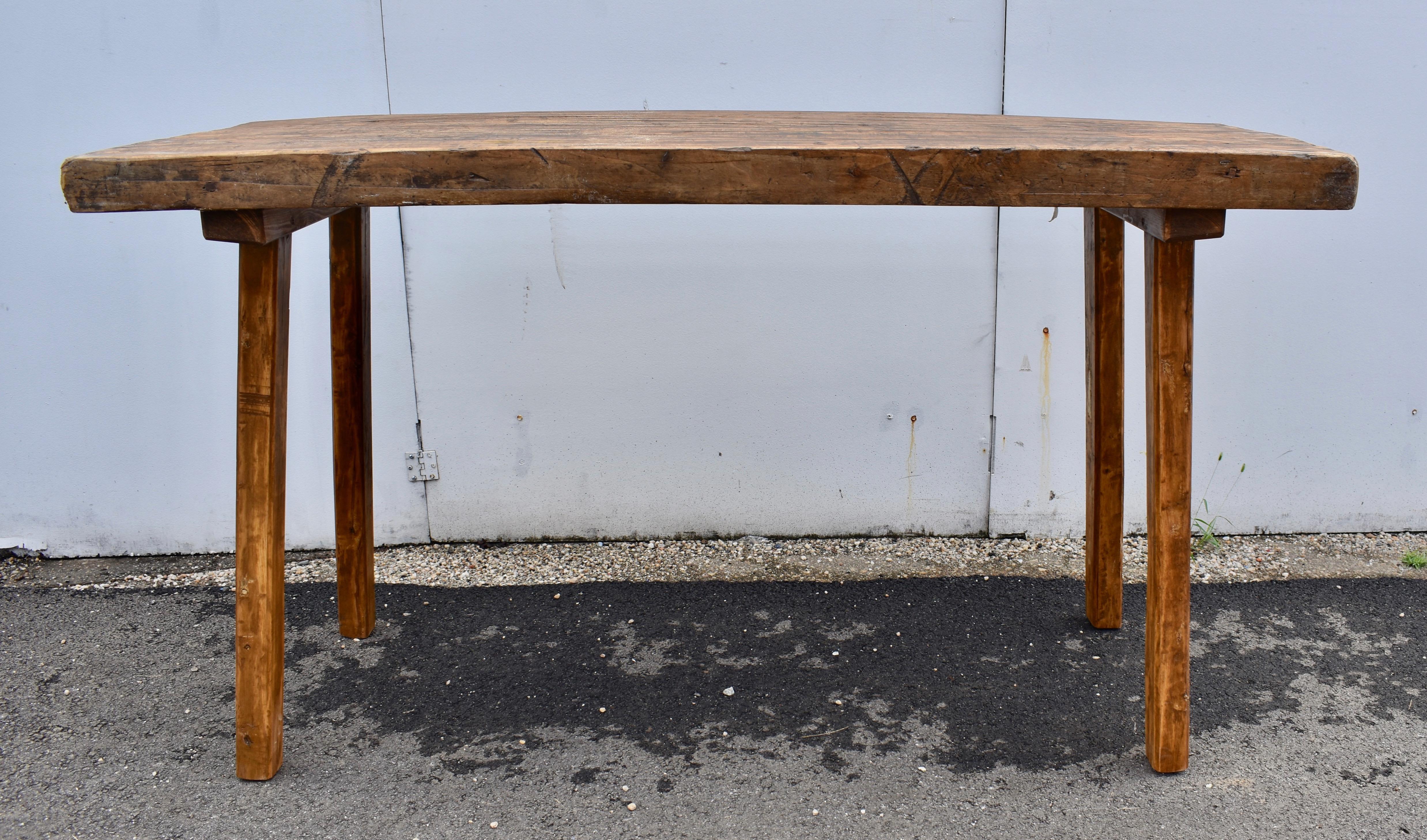 Two slabs of oak almost 3” thick are joined with a spline to form the top of this large Pig Bench.  Square oak legs are chamfered at the corners into octagons, with their tops embedded into cleats, slightly splayed for stability.  The cleats are