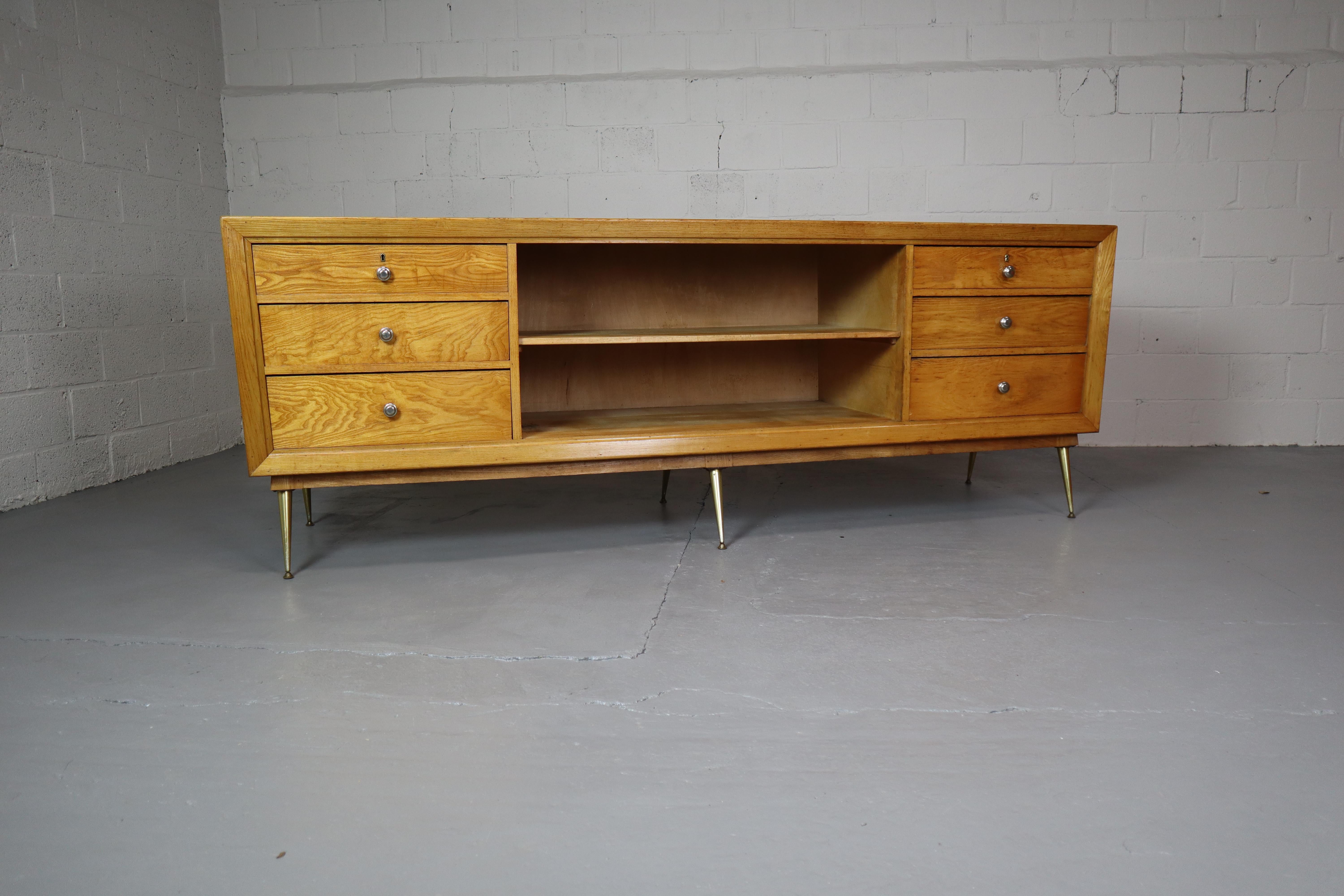 Stunning vintage shop counter with 6 big drawers and lots of storage space!
The counter is made of oak veneer.
The top has a formica finish.
Can be used perfectly as a sideboard or room divider.
Measures: W 244 H 89 D 70 cm.