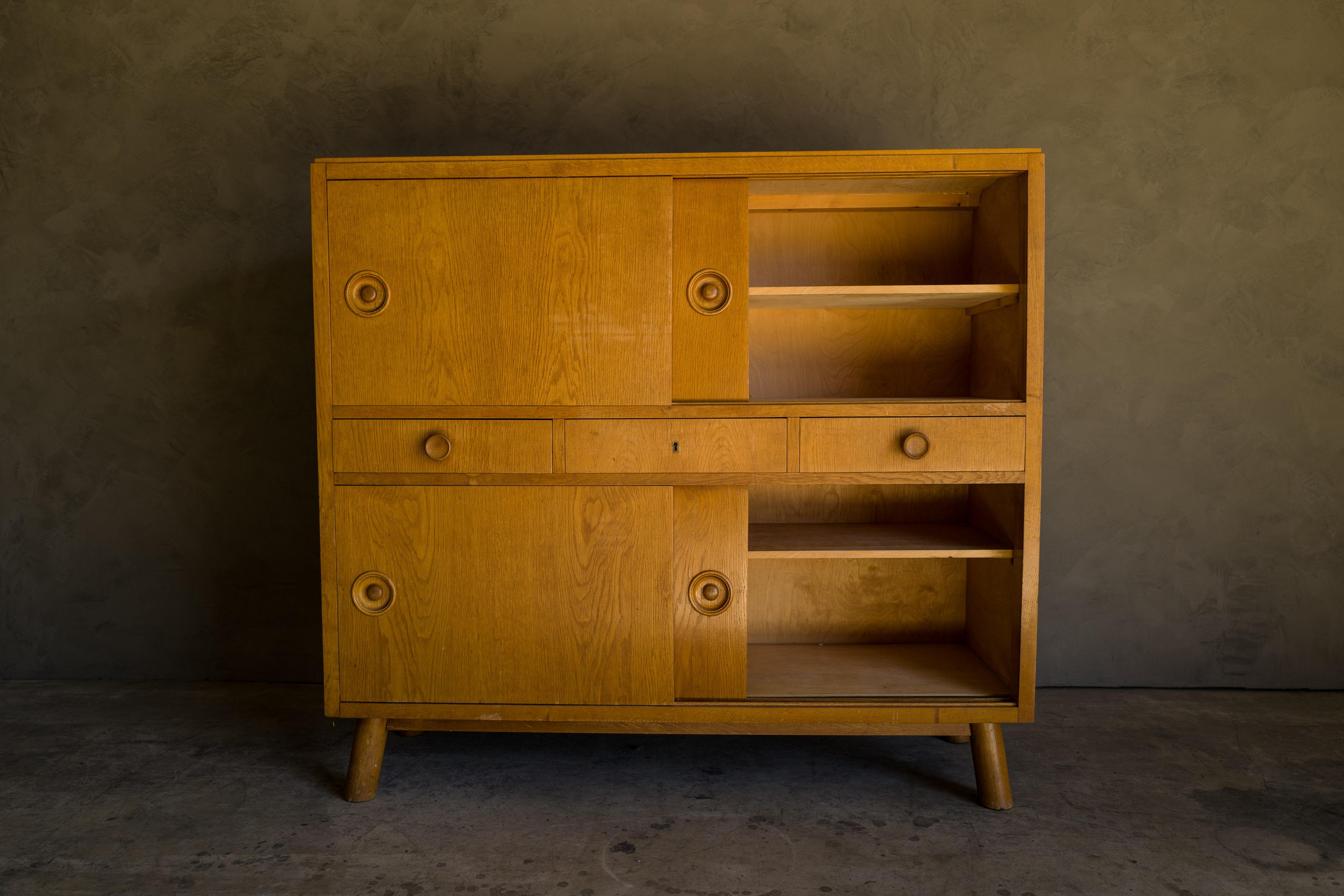 Vintage oak sideboard from Denmark, 1960s. Rare tall model with sliding doors and drawers. Light wear and patina.