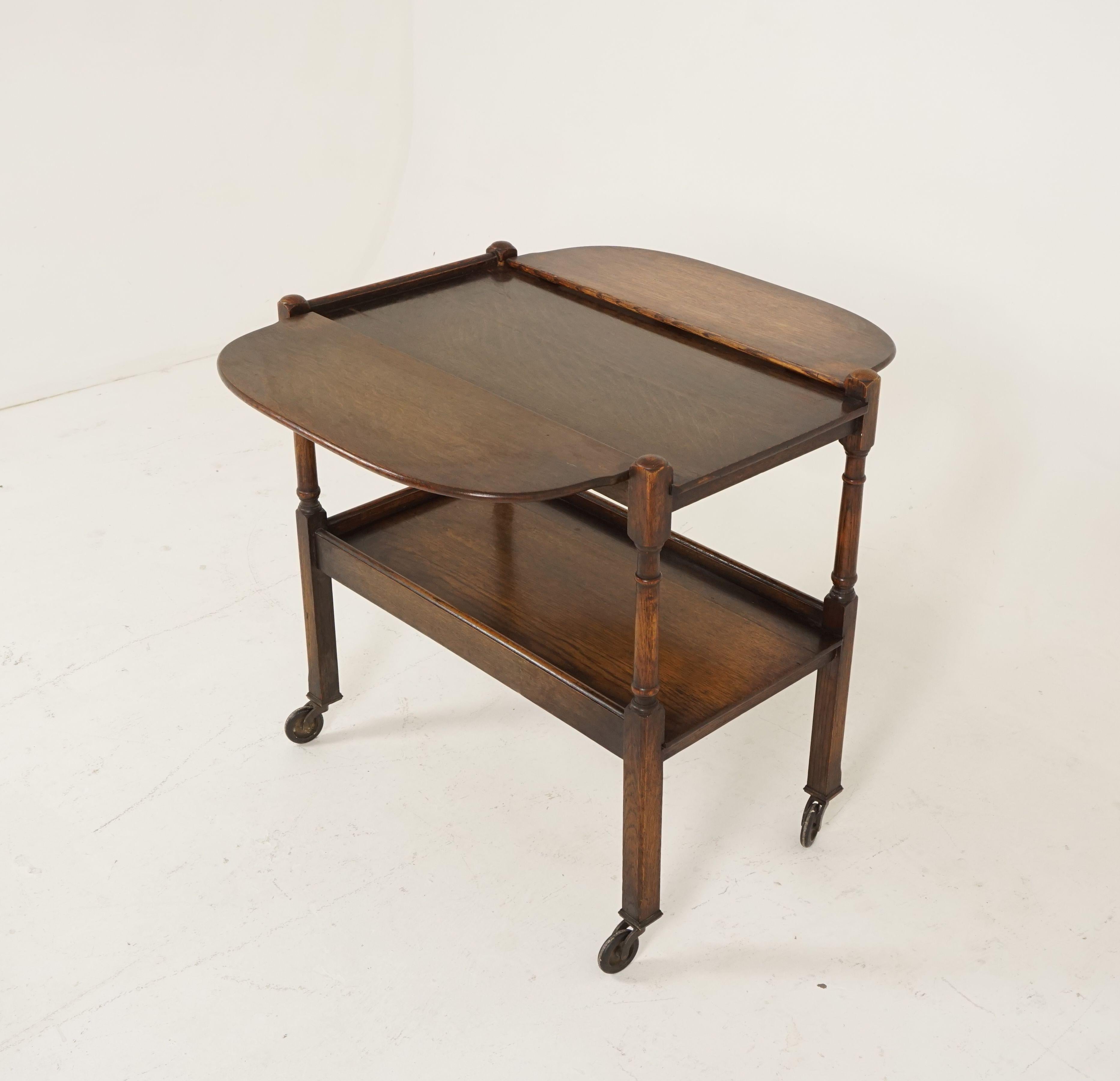 Vintage oak tea trolley, bar cart, two tier, Scotland 1930, B2464

Scotland 1930
Solid oak & veneer
Original finish
Rectangular top with three quarter gallery on top
Pair of leaves on the side that can be raised to provide additional serving