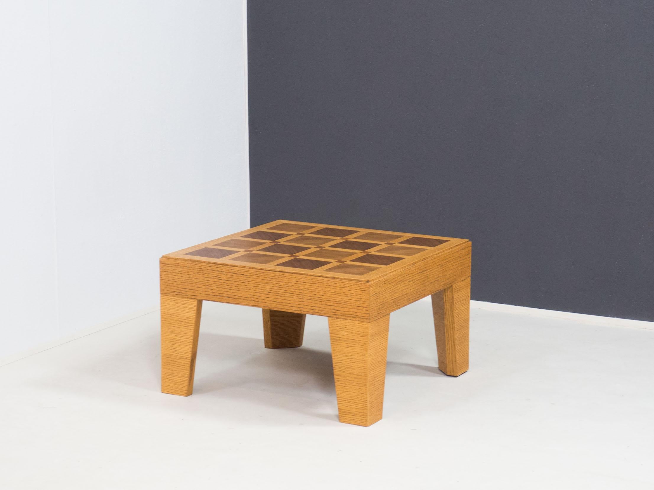 Vintage square low coffee table with graphic design, most likely from the late 1970s.

This unusual table is made from an oak and walnut veneered top in a art deco type pattern.
The sides and legs are also veneered in oak.

This table is in