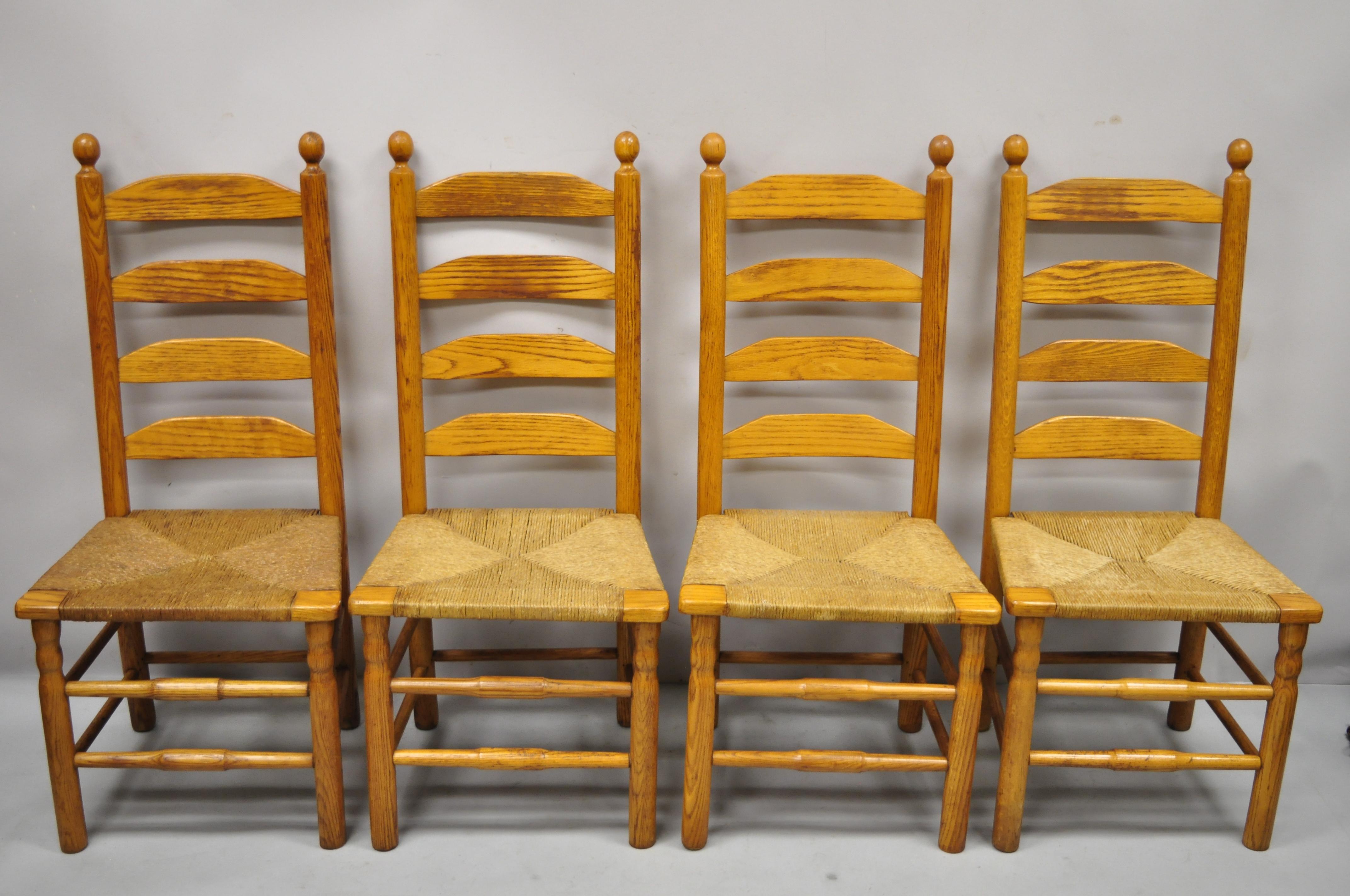 Vintage oak wood rush seat tall ladder back dining room primitive rustic chairs- Set of 6. Item features woven rush seats, beautiful wood grain, very nice vintage set, great style and form. Circa late 20th century. Measurements: 42