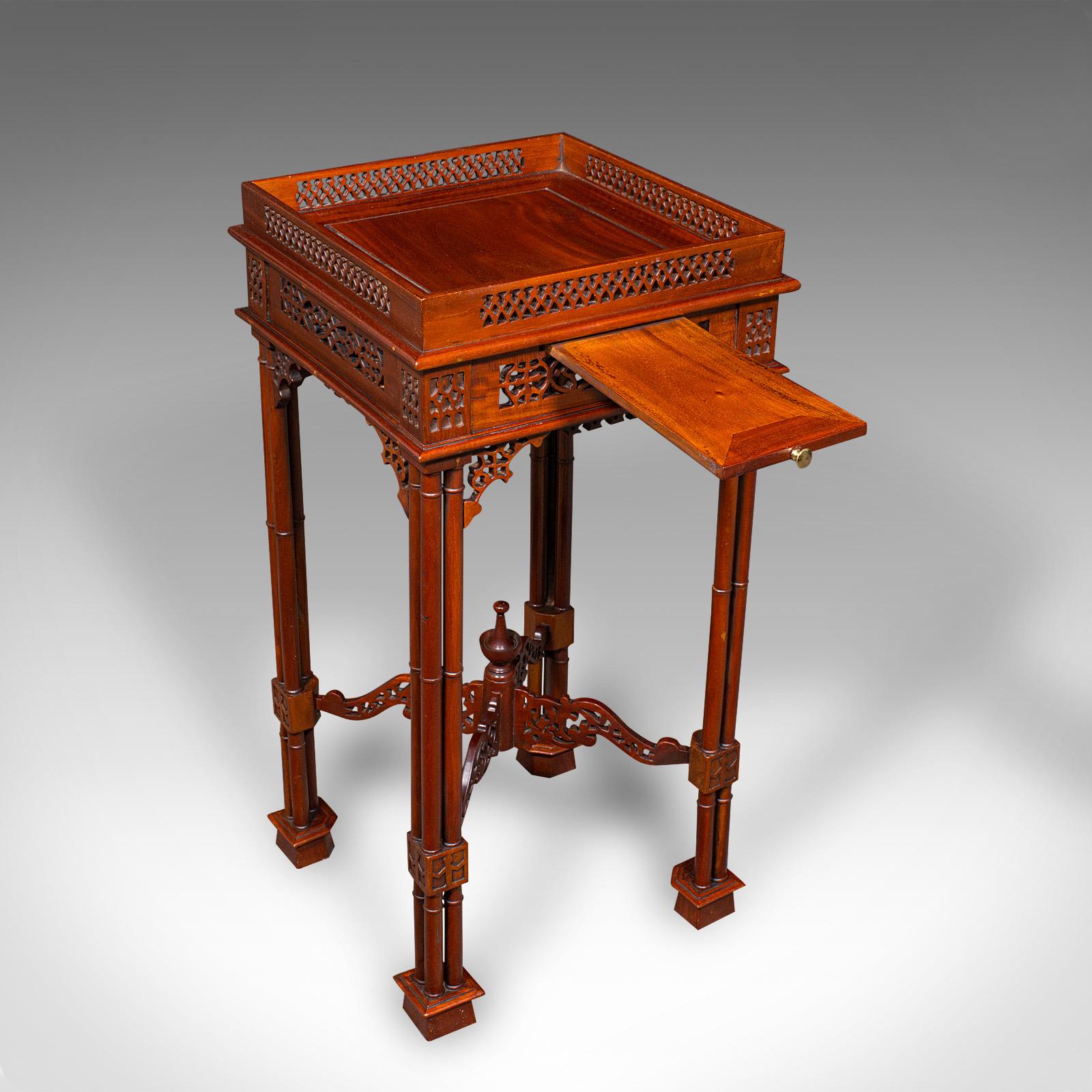 This is a charming vintage occasional table. An Oriental, mahogany lamp or side table in Chippendale revival taste, dating to the late 20th century, circa 1970. With ornate craftsmanship and timeless elegance, this decorative piece enhances any