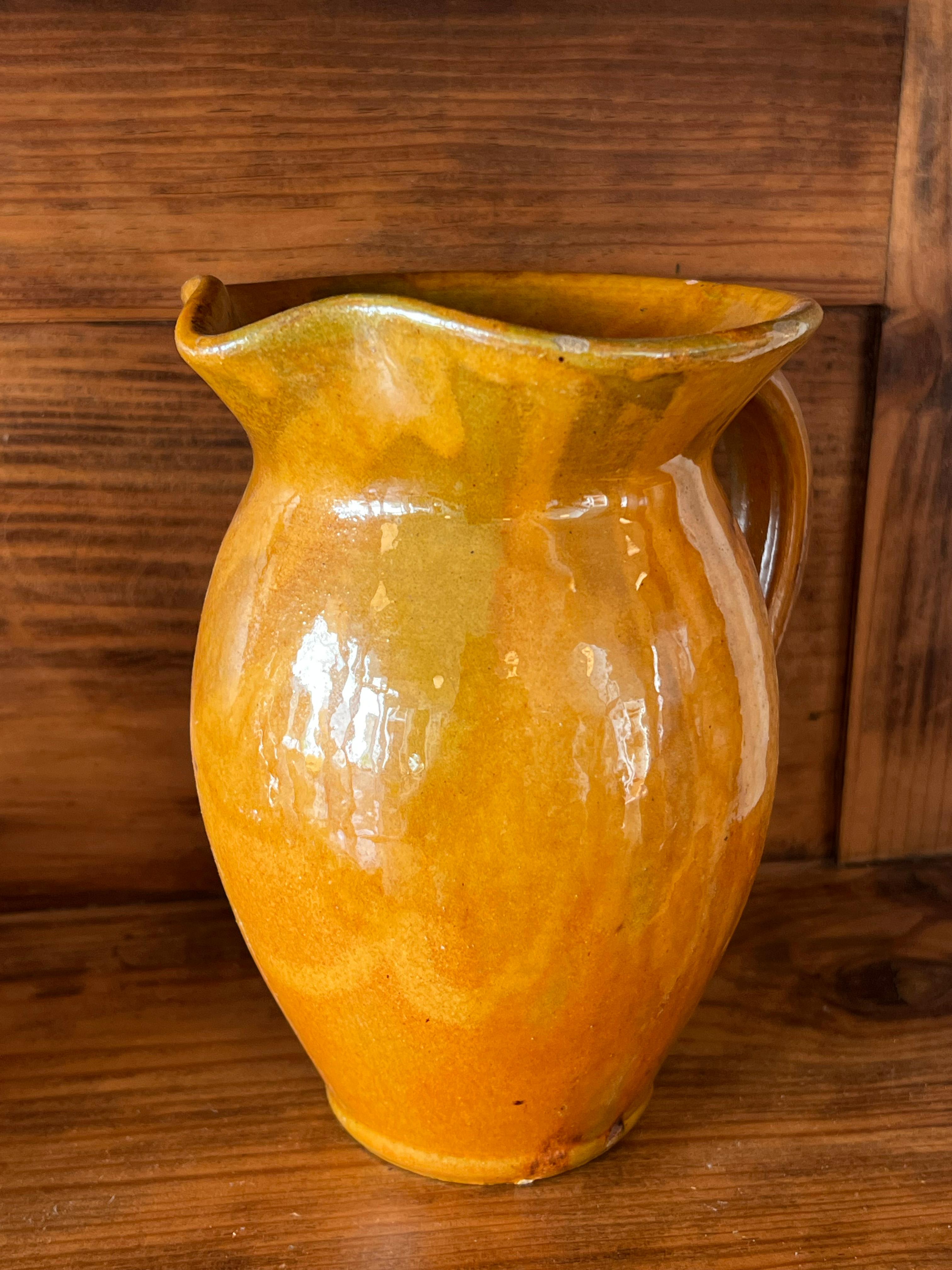 Vintage ochre-coloured jug from the Biot factory in Provence, France. The stamp with the four letters BIOT is visible in the glaze. Very pretty ochre colour with shades of green khaki in places, completely typical of Provençal colours. This small