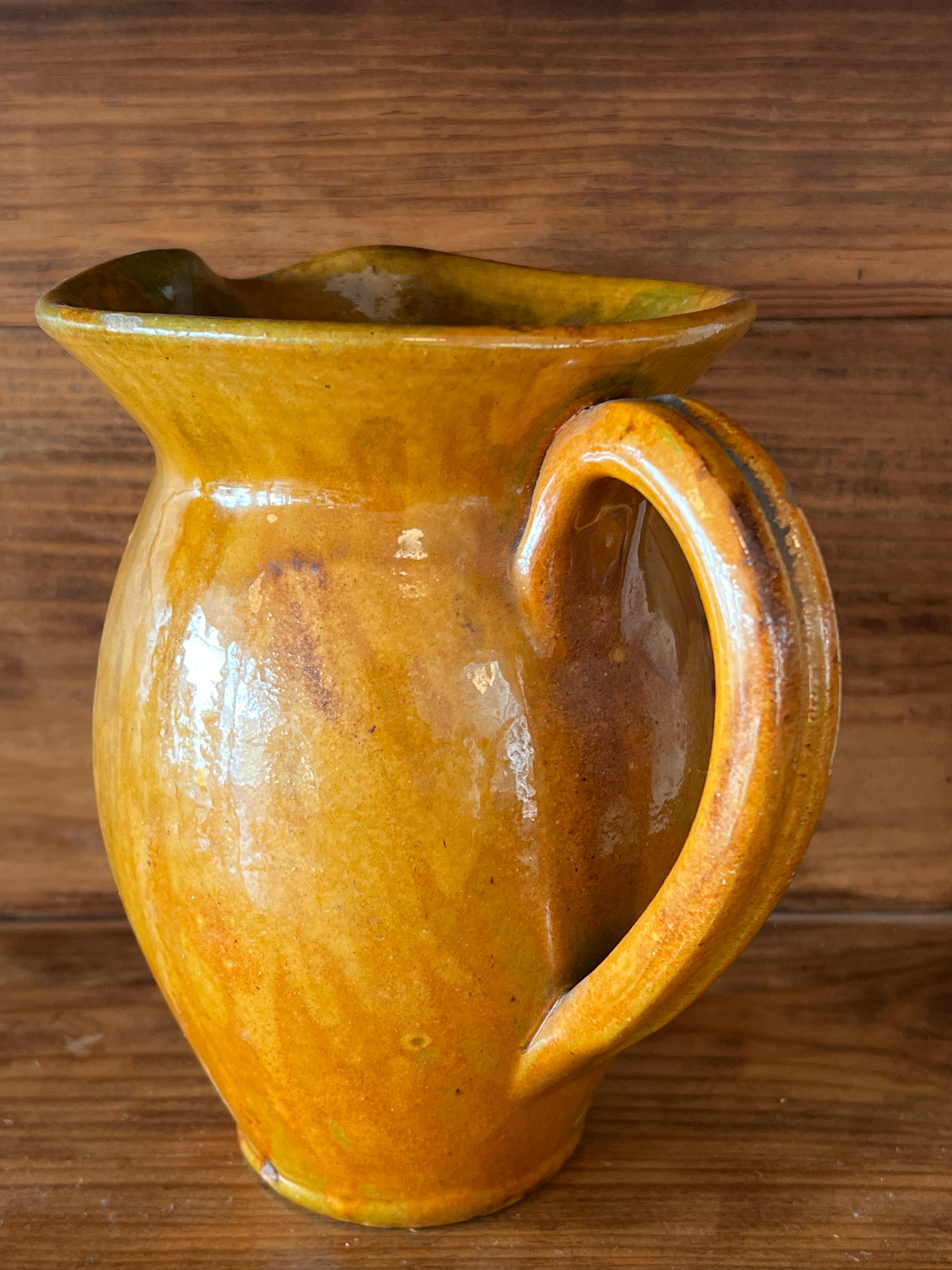 Enameled Vintage ochre-coloured pitcher from the Biot factory in Provence, France For Sale