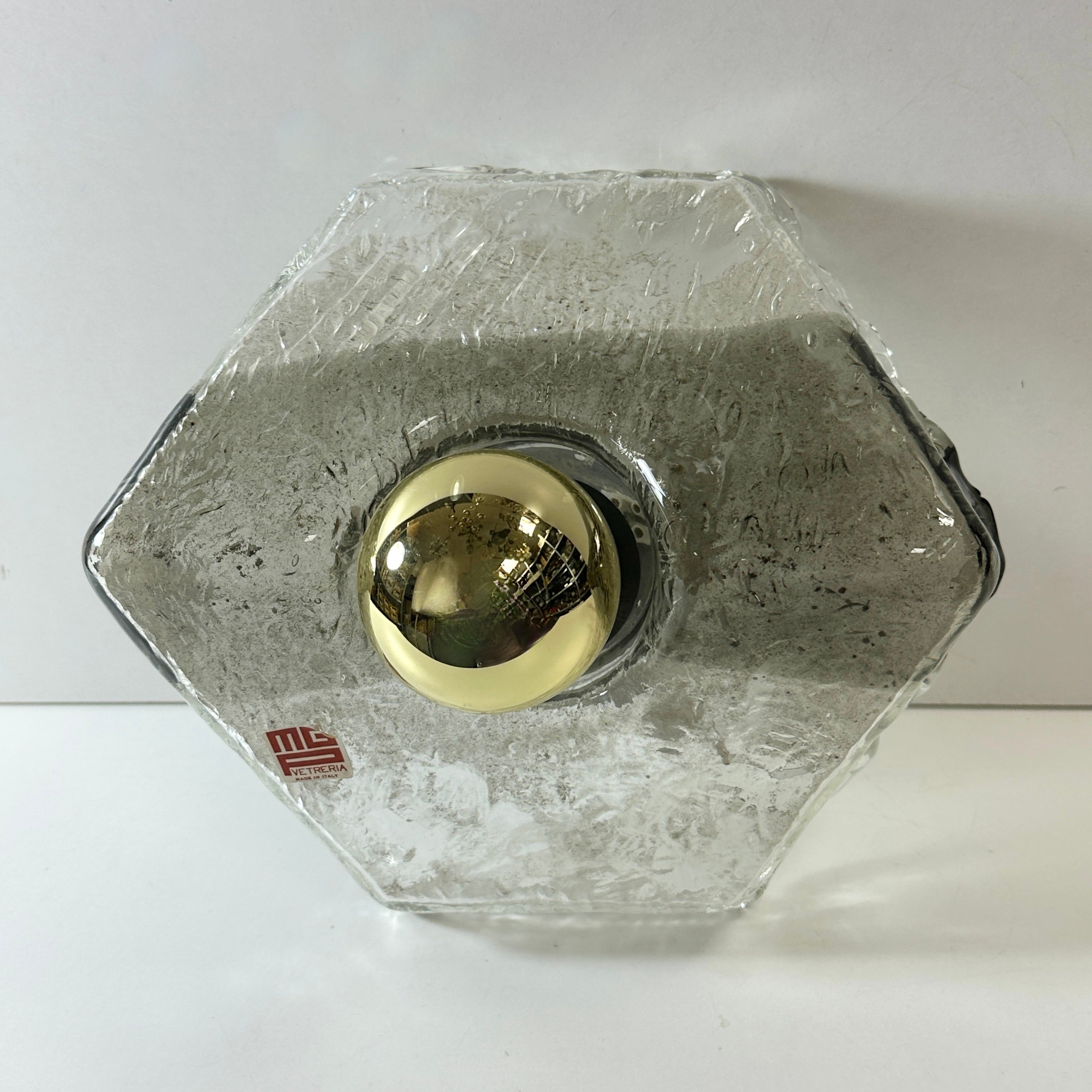 A beautiful ice glass flush mount, designed in the style of Mazzega Light, by MGP Vetreria, Italy. Made in Murano Italy in the 1970s. Gorgeous textured glass wall light with metal fixture. The Fixture requires one European E27 / 110 Volt Edison