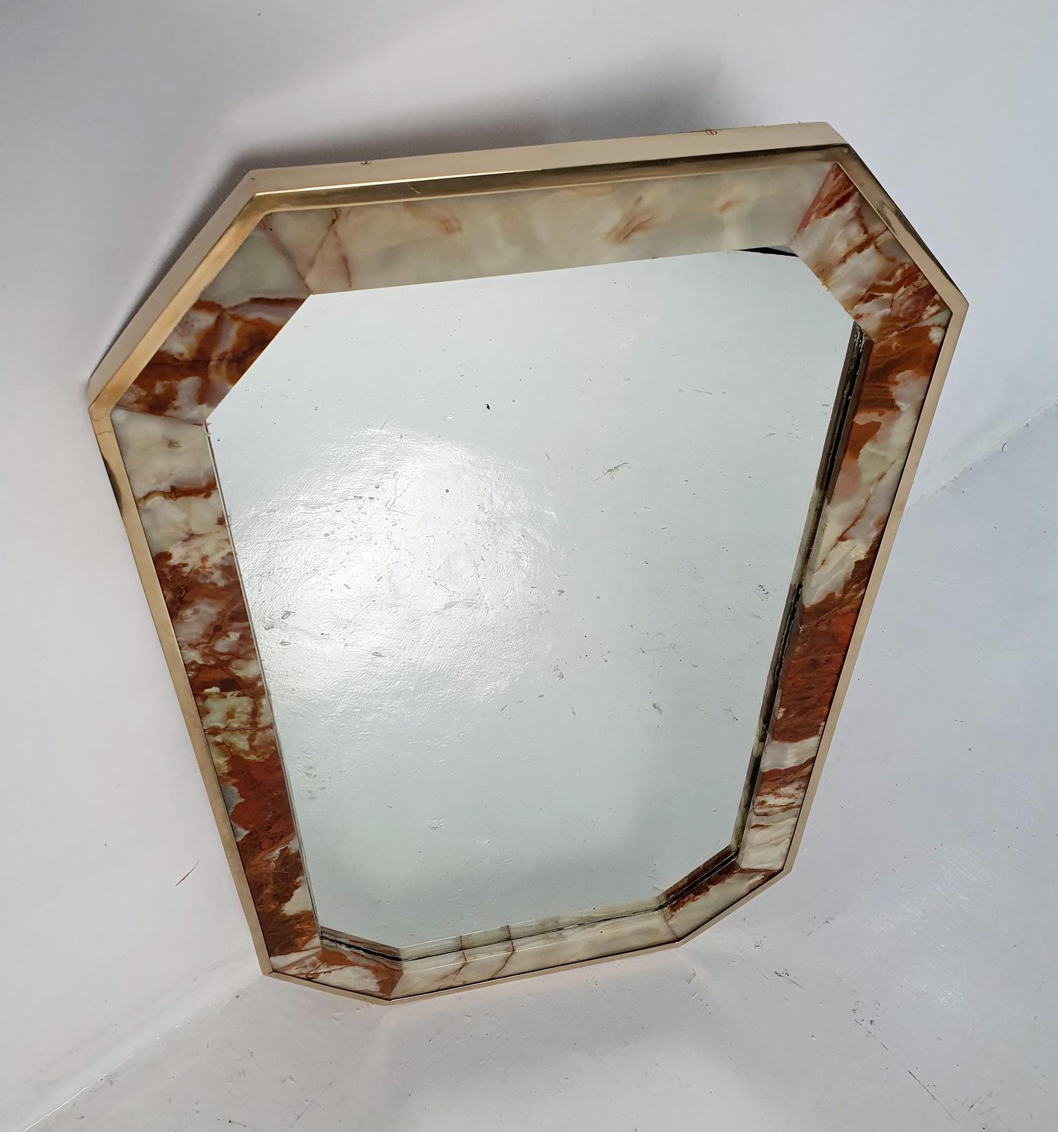 Introduce a touch of Italian luxury to your space with this captivating octagonal wall mirror from the 1970s. The mirror features an outer frame expertly crafted from solid brass, complemented by a lustrous inner frame made of solid onyx that