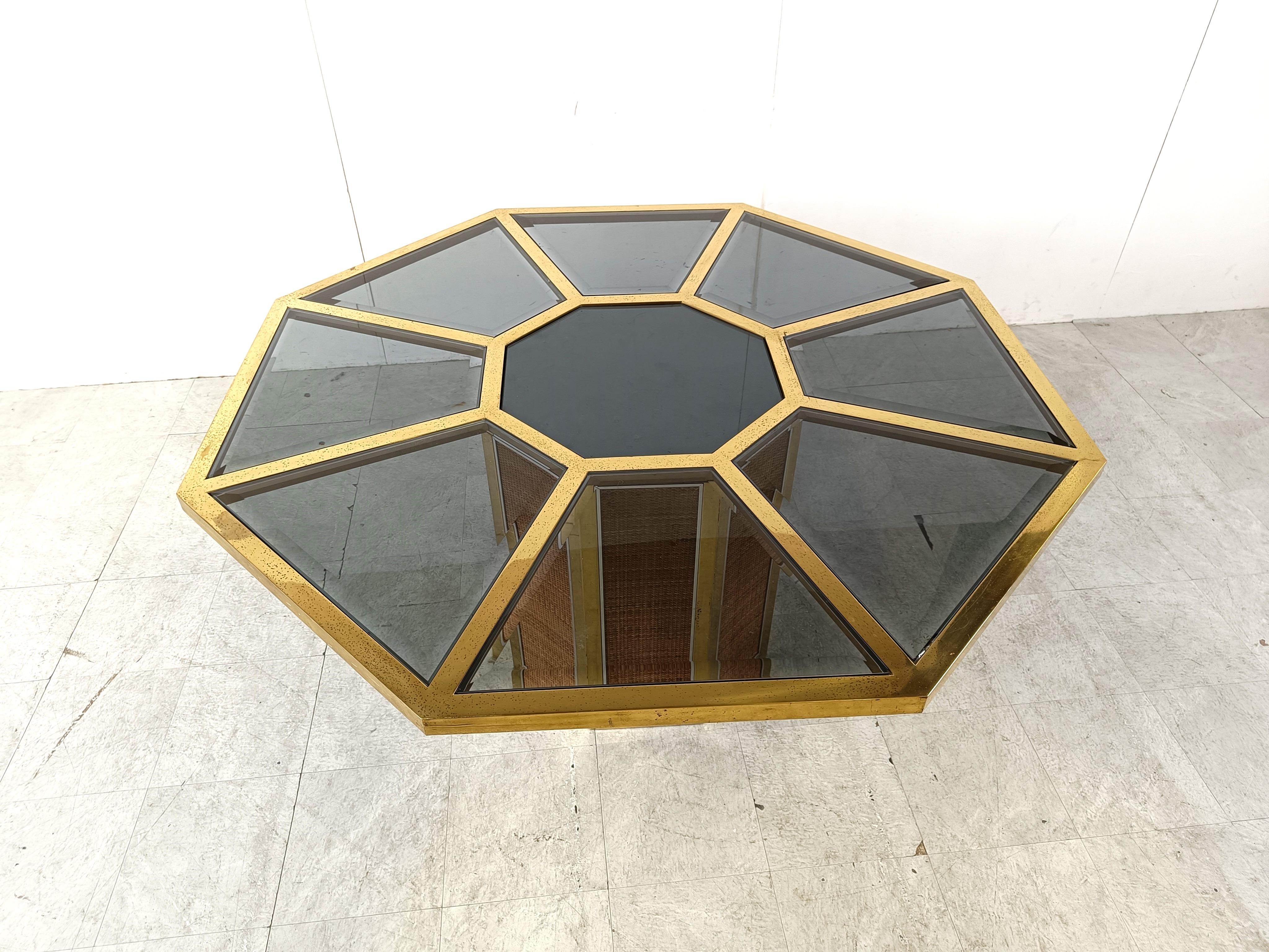 Hollywood regency dining table by Romeo Rega/

Made from an octogonal brass frame with inlaid mirrored glass.

The base is made from brass with wicker panels.

Condition: Some glasses have chips and the frame has some patina/wear. - Overall good