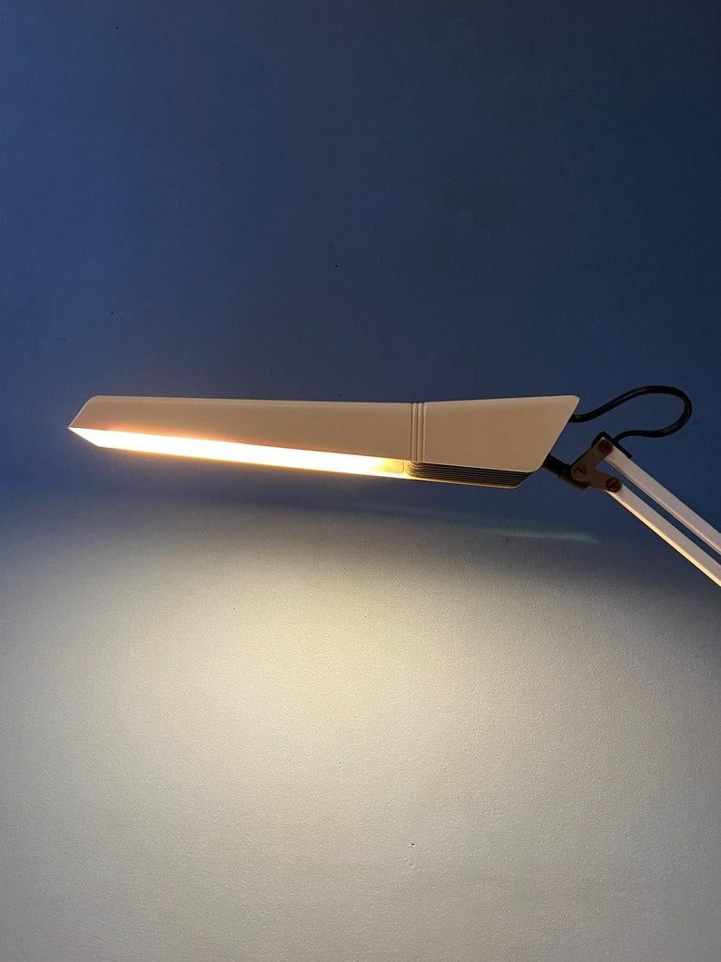 Vintage office desk lamp with clamp mechanism. The arm be adjusted in any way desirable. Also the shade it self can move. The lamp requires an E27/26 bulb and currently has an EU-plug (easily used outside EU with plug converter).

Additional