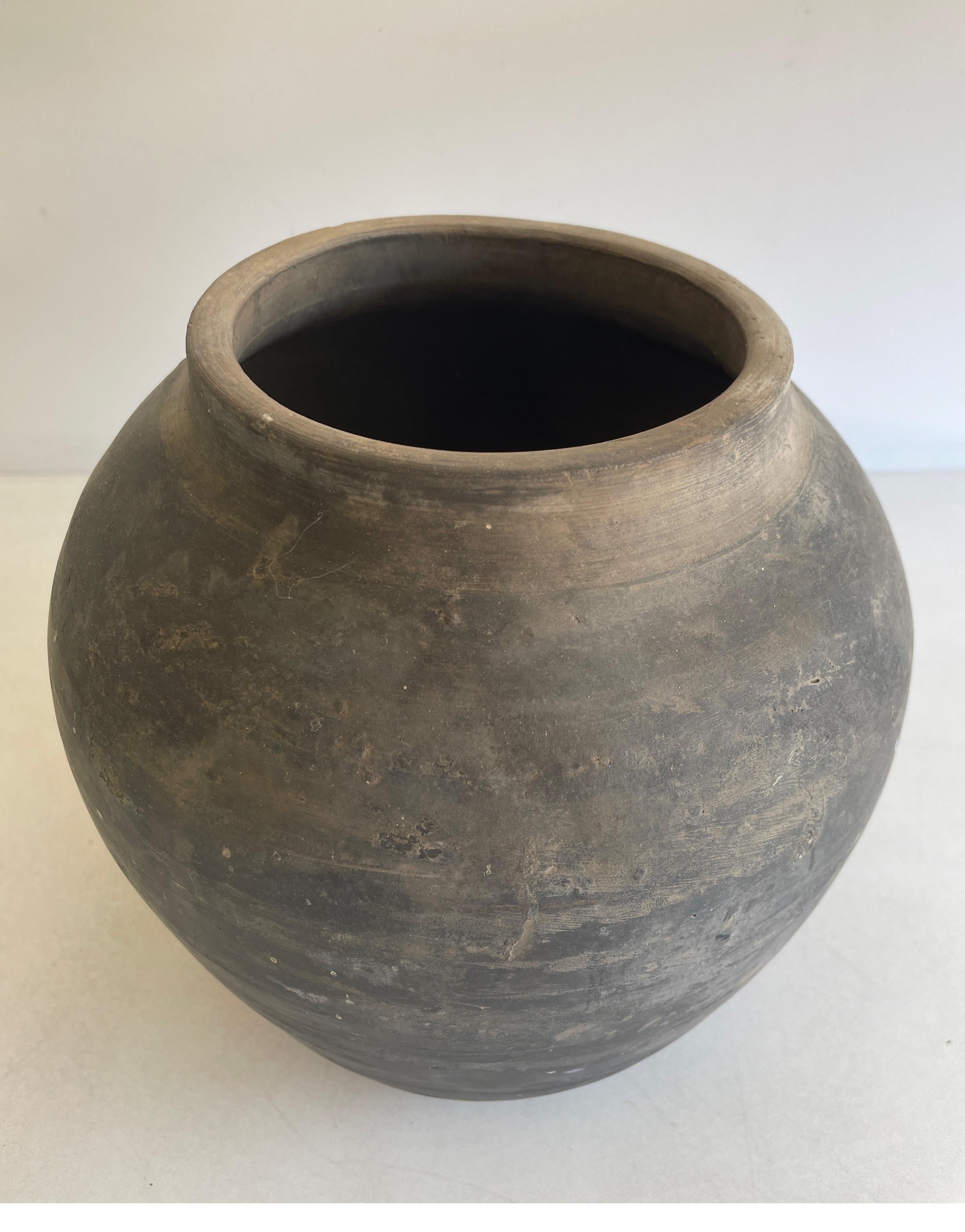 Vintage Pottery Beautiful and rich in character, this vintage oil pot adds just the right amount of texture + warmth where you need it. Stunning faded black/ brown unglazed finish with warm terra-cotta accents. Some have a more faded appearance than